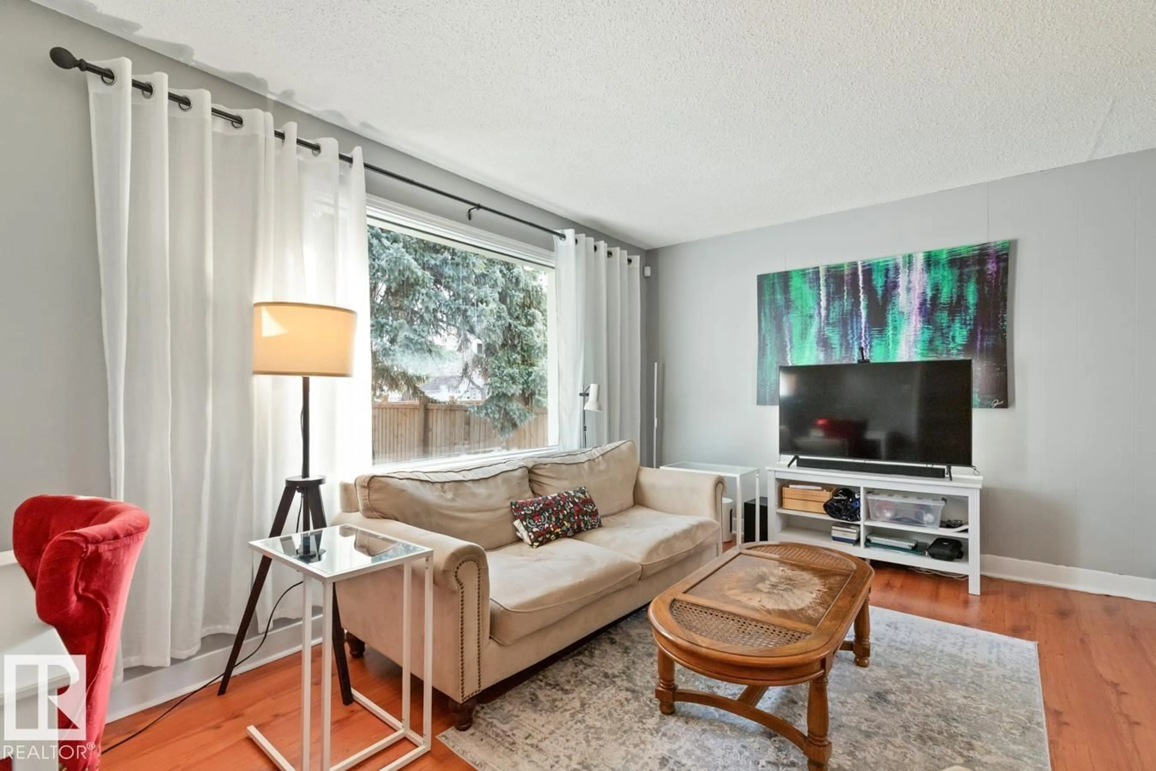 Living room with furniture, wood/laminate floor for NW - 12510 81 ST, Edmonton Alberta T5B2T9