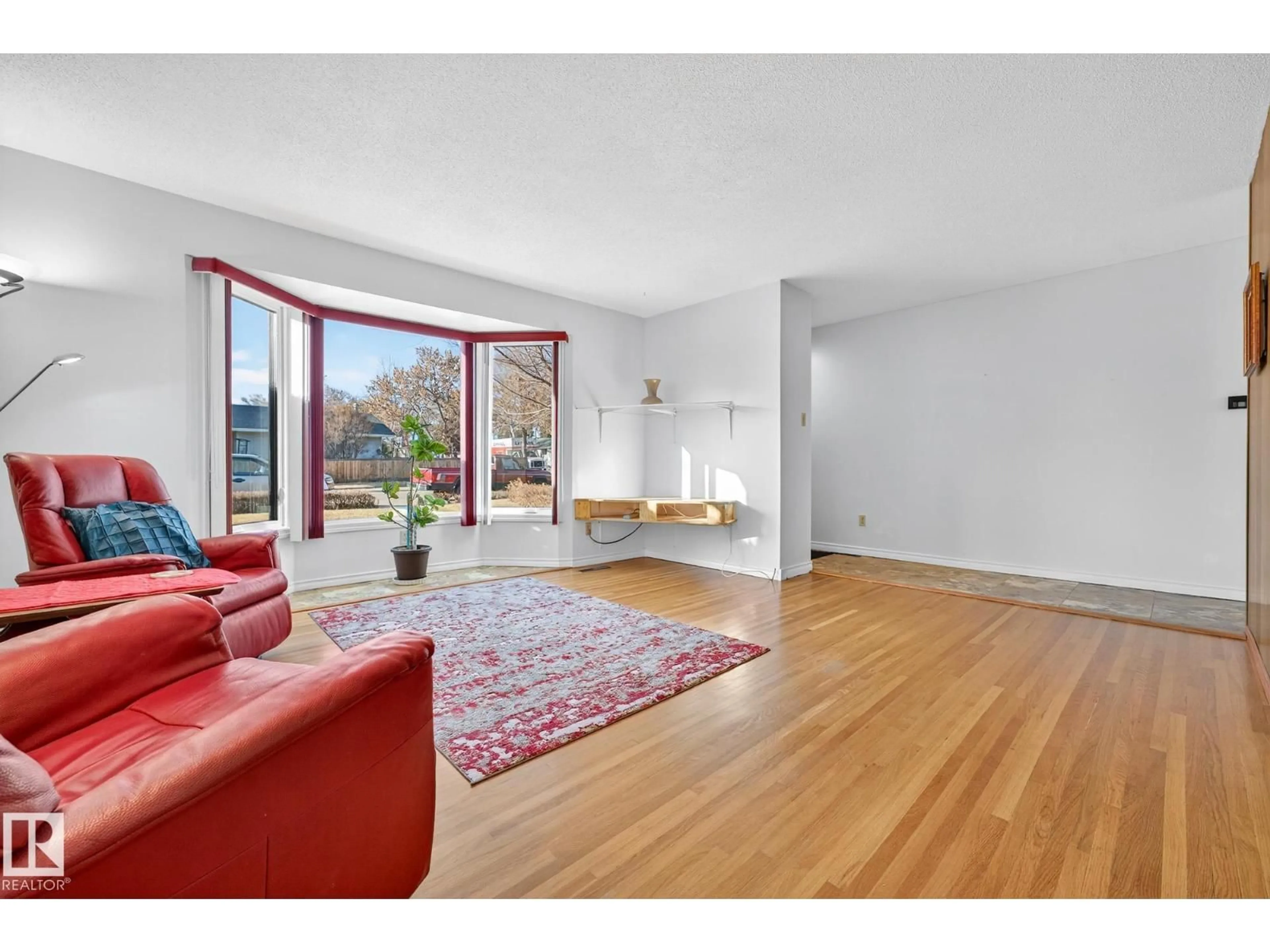 Living room with furniture, wood/laminate floor for NW - 10715 36 ST, Edmonton Alberta T5W2A5