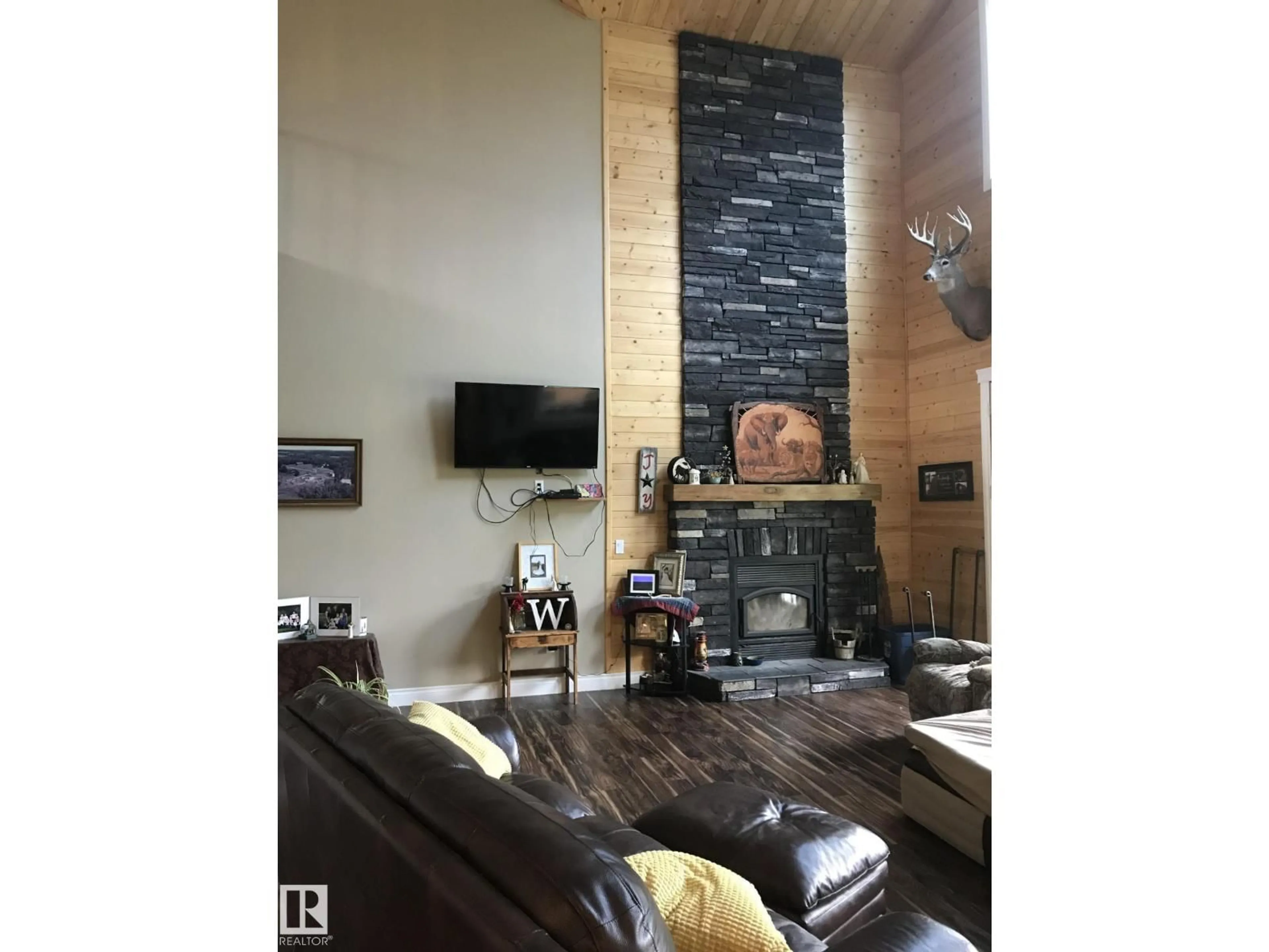 Living room with furniture, wood/laminate floor for 620081 RGE RD 62, Rural Woodlands County Alberta T0G1A0