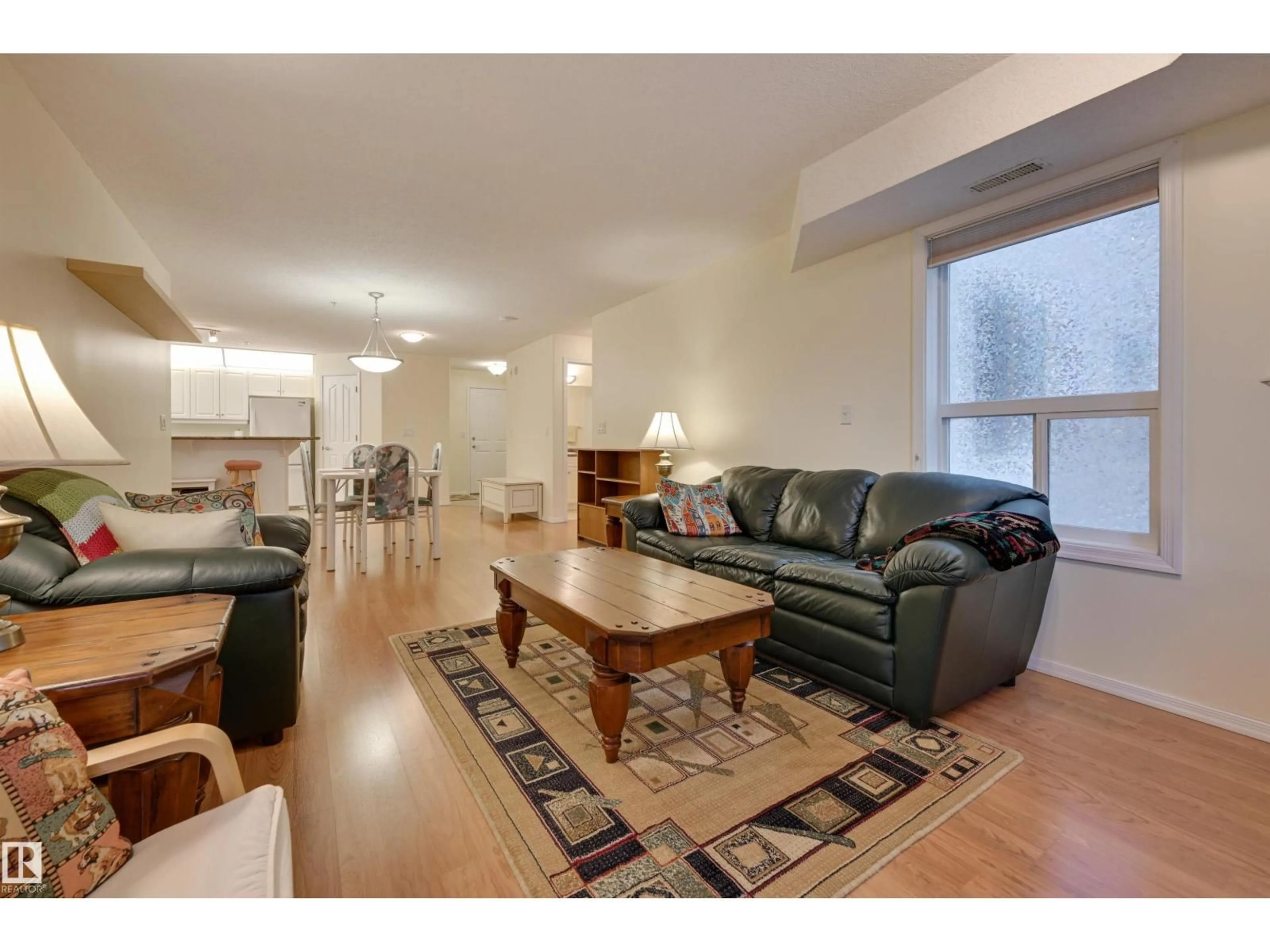 Living room with furniture, wood/laminate floor for #336 - 9008 99 AV, Edmonton Alberta T5H4M6