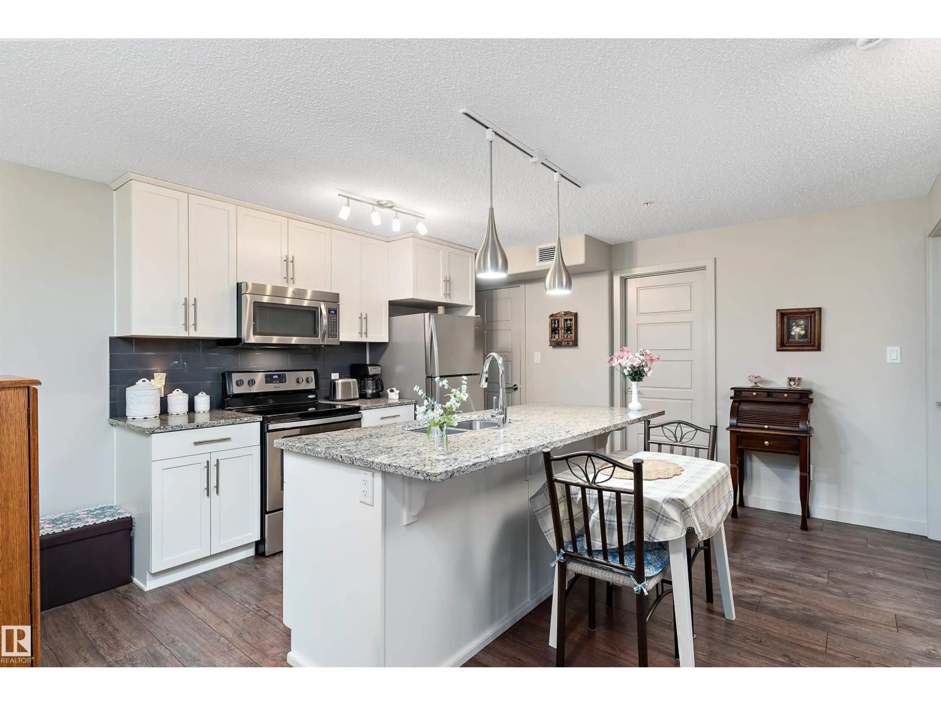 Open concept kitchen, wood/laminate floor for #213 - 5510 SCHONSEE DR, Edmonton Alberta T5Z0N9