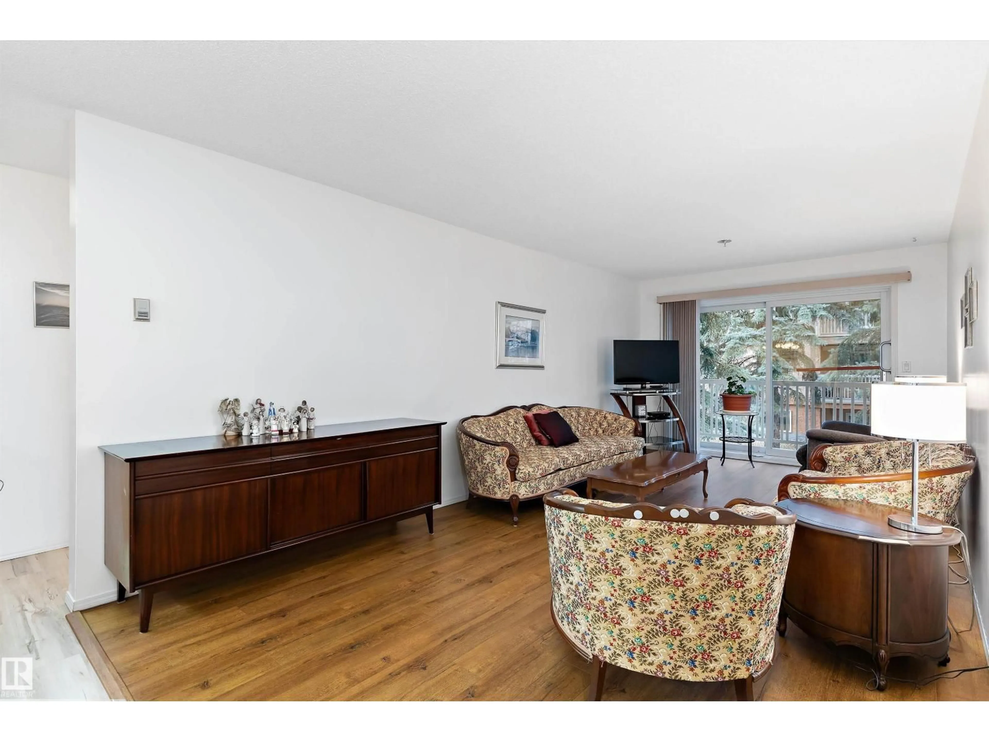 Living room with furniture, wood/laminate floor for #209 - 10915 21 AV, Edmonton Alberta T6J6X2