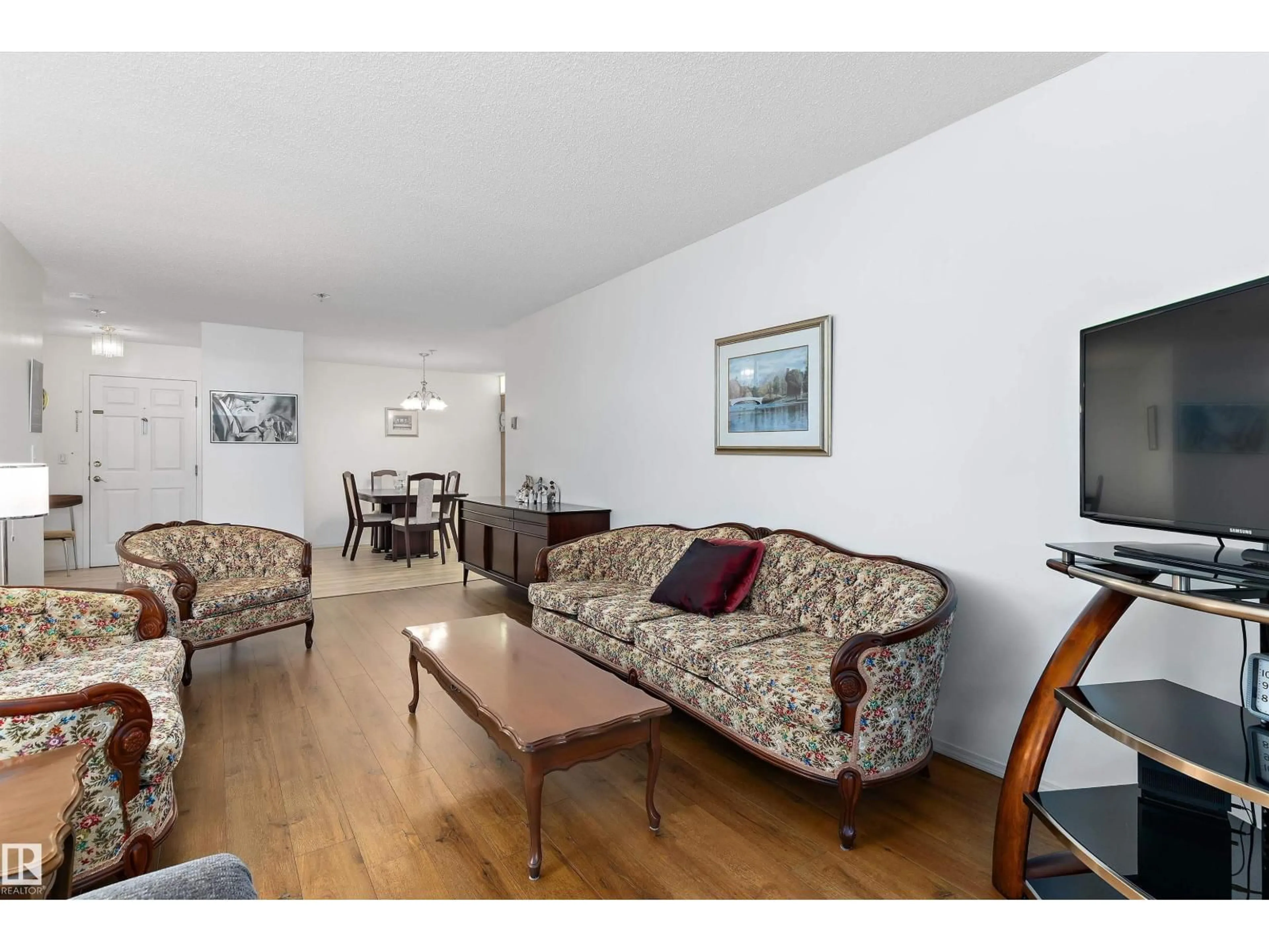 Living room with furniture, wood/laminate floor for #209 - 10915 21 AV, Edmonton Alberta T6J6X2