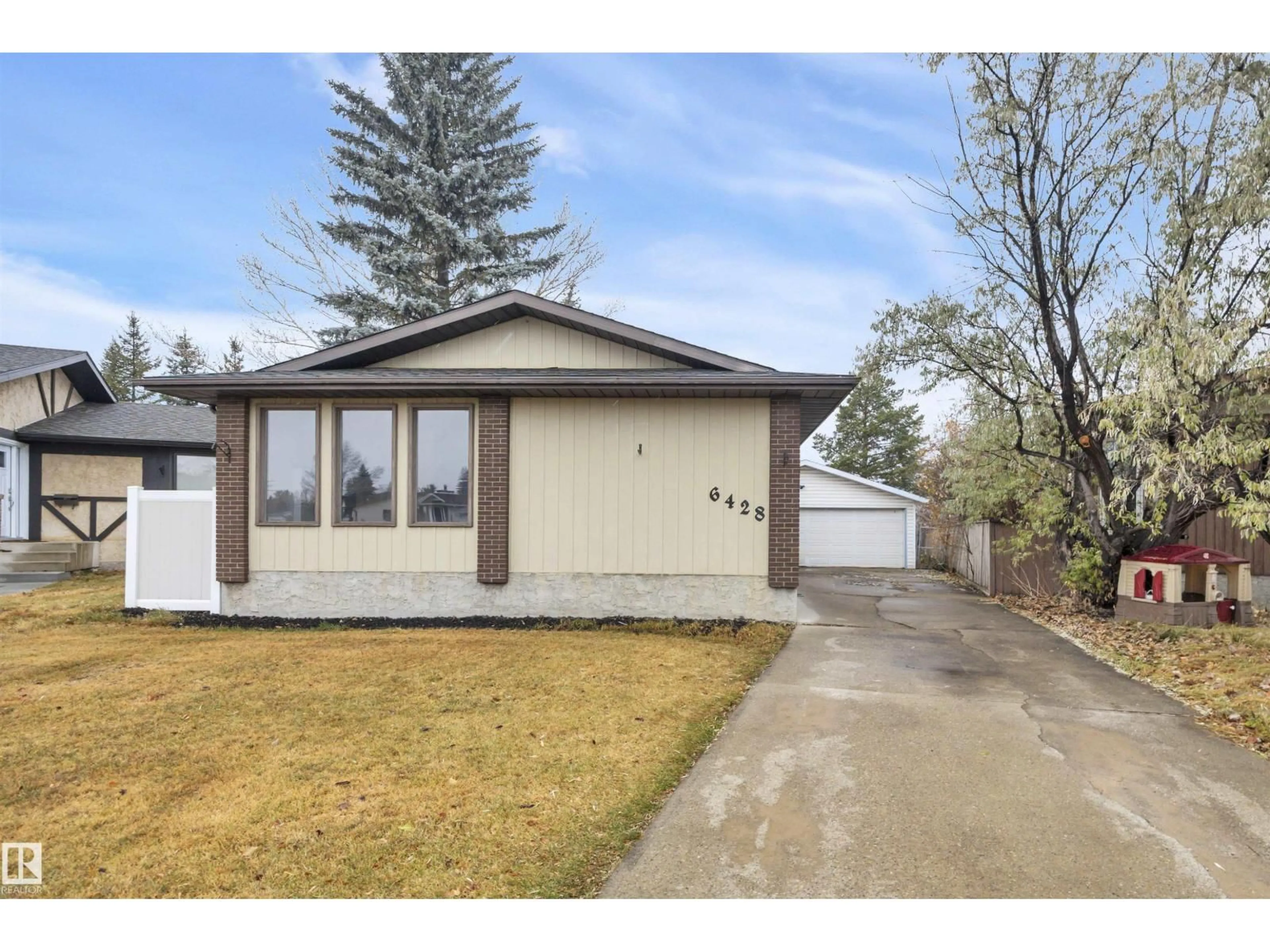 Home with vinyl exterior material, street for 6428 15 AV NW, Edmonton Alberta T6L1S6