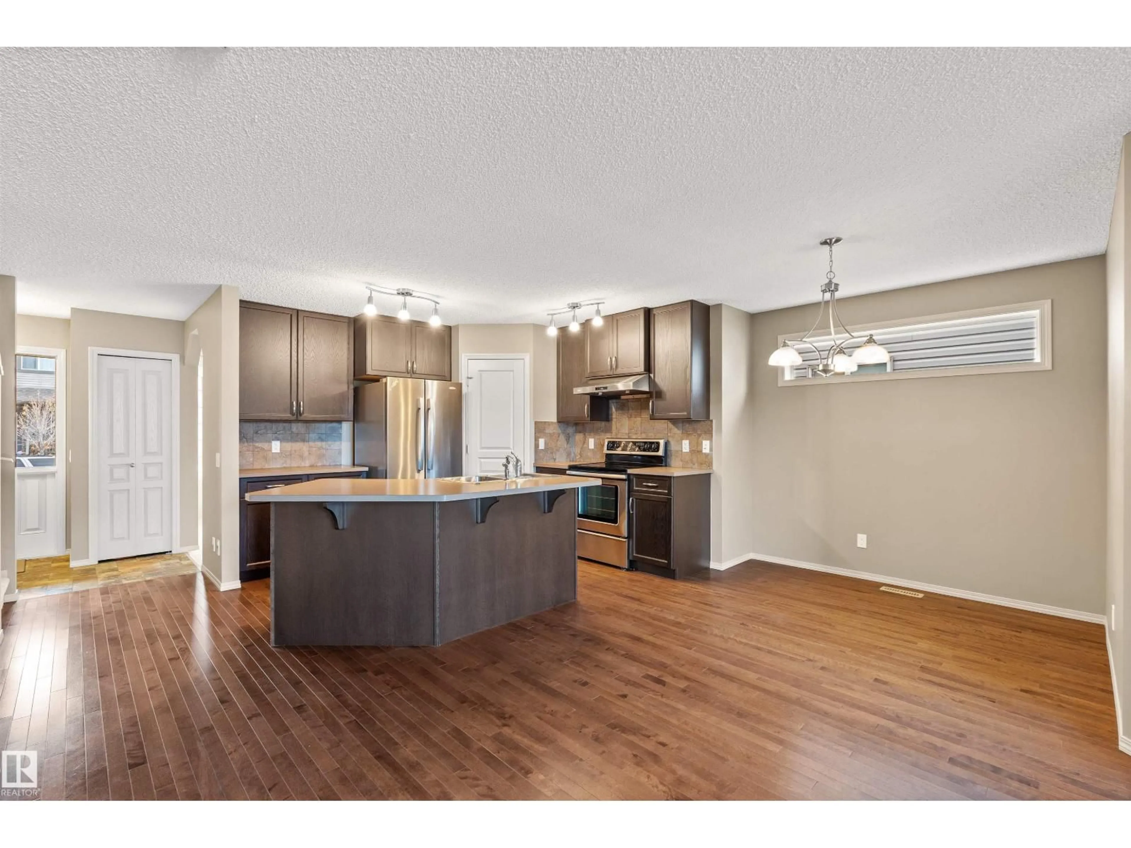Open concept kitchen, wood/laminate floor for 21328 95 AV, Edmonton Alberta T5T4C9