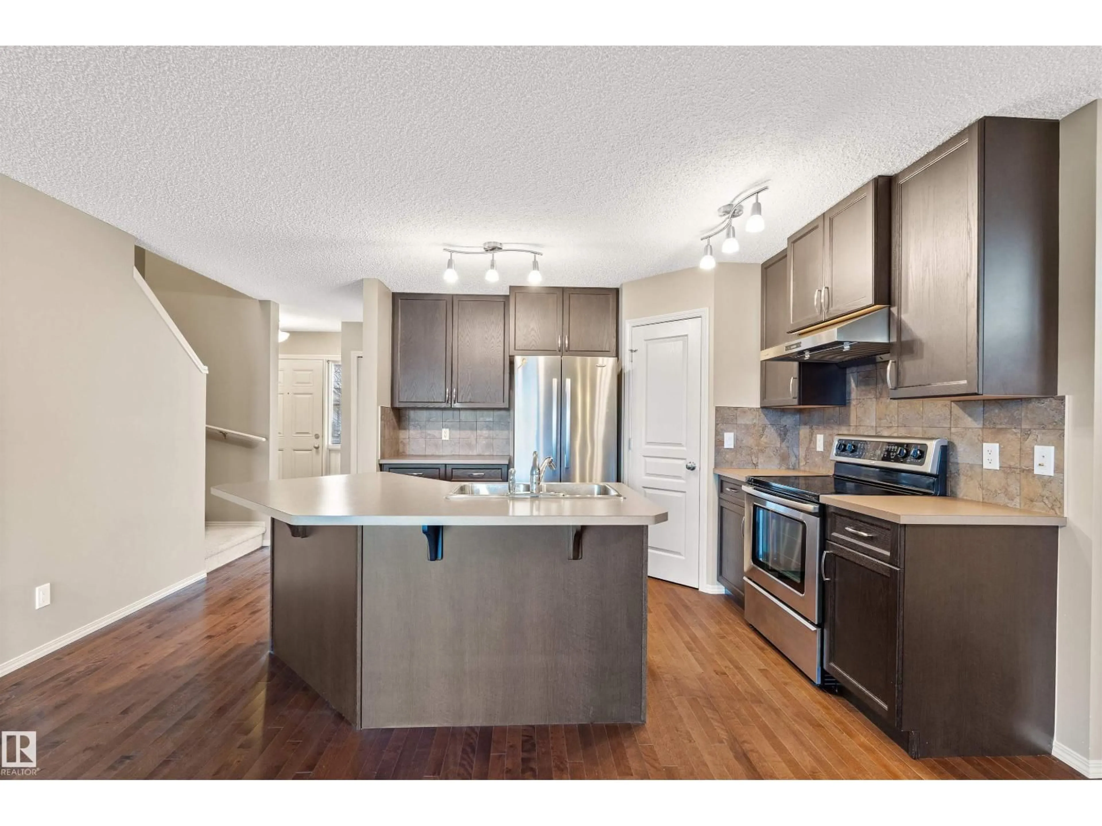 Open concept kitchen, wood/laminate floor for 21328 95 AV, Edmonton Alberta T5T4C9