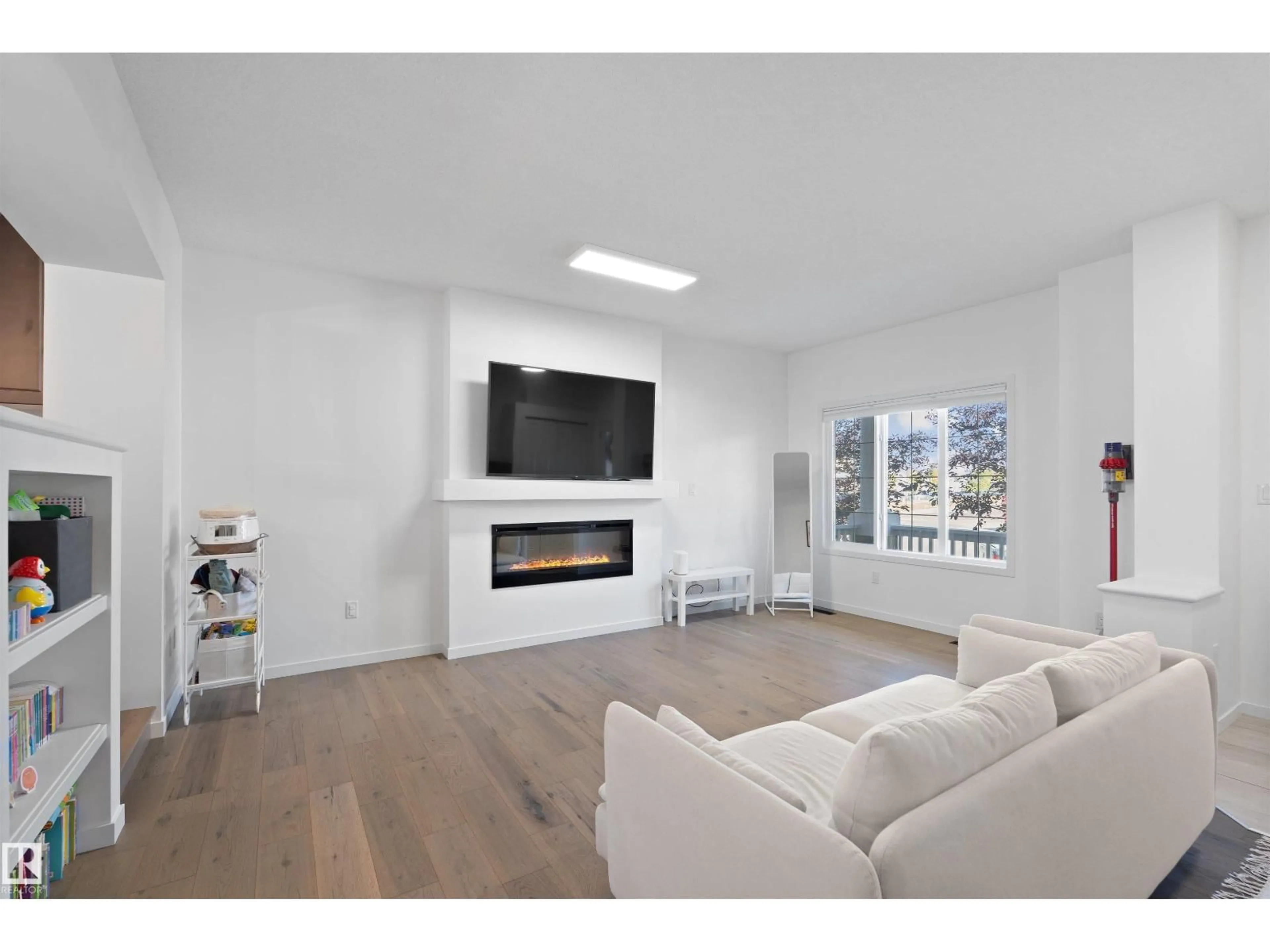 Living room with furniture, wood/laminate floor for 2208 82 ST, Edmonton Alberta T6X2J6