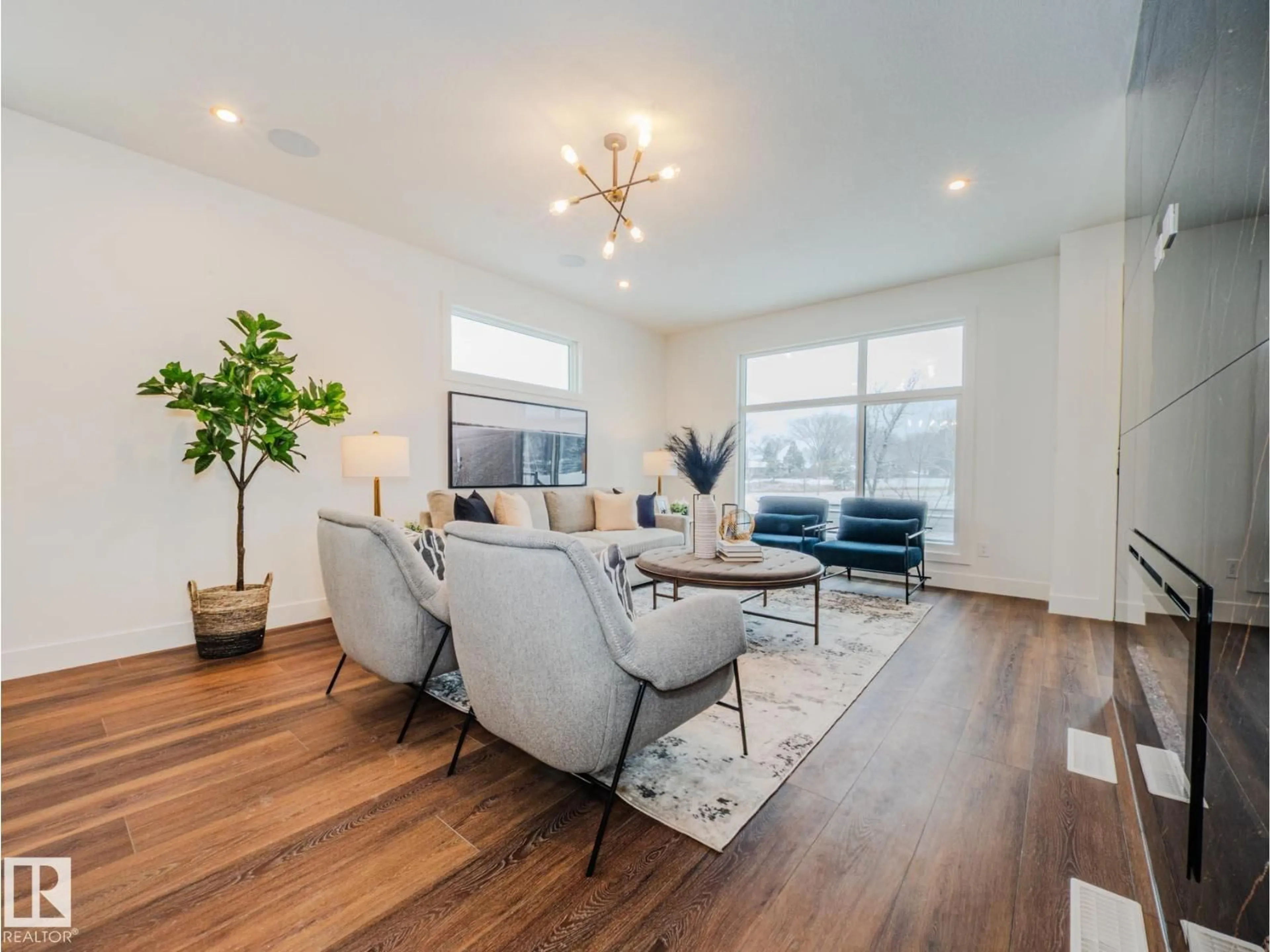 Living room with furniture, wood/laminate floor for 7607 98 AV, Edmonton Alberta T6A0B3