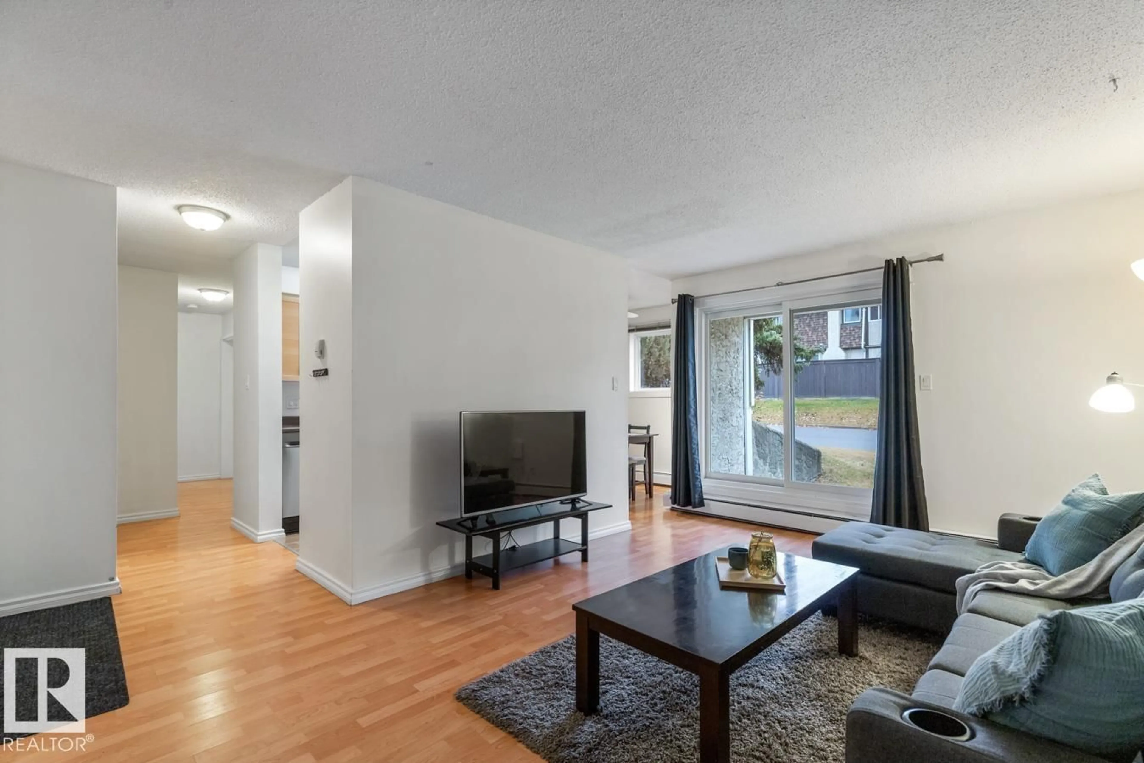 Living room with furniture, wood/laminate floor for 12 - 11245 31 AV, Edmonton Alberta T6J3V5