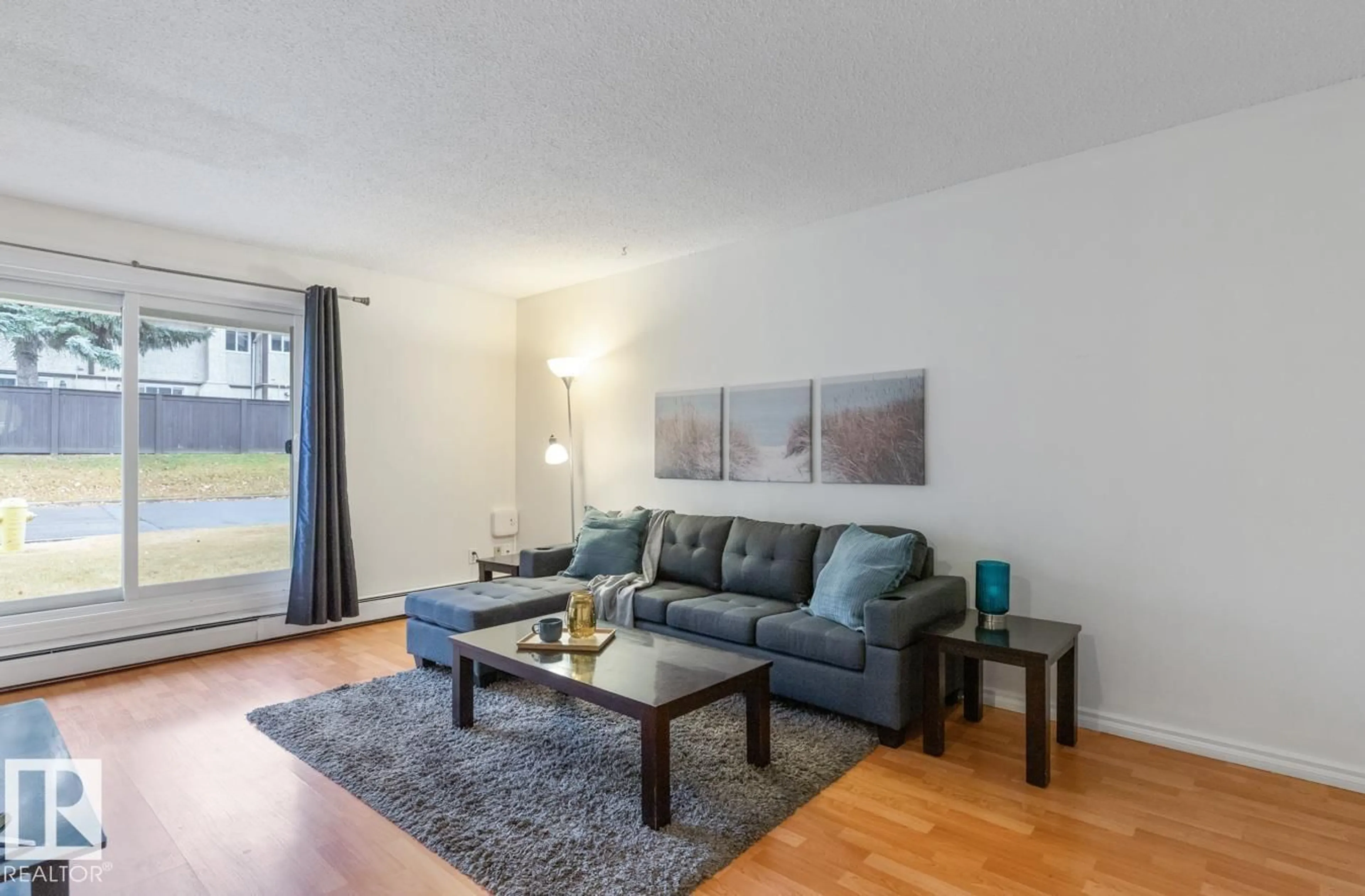 Living room with furniture, wood/laminate floor for 12 - 11245 31 AV, Edmonton Alberta T6J3V5