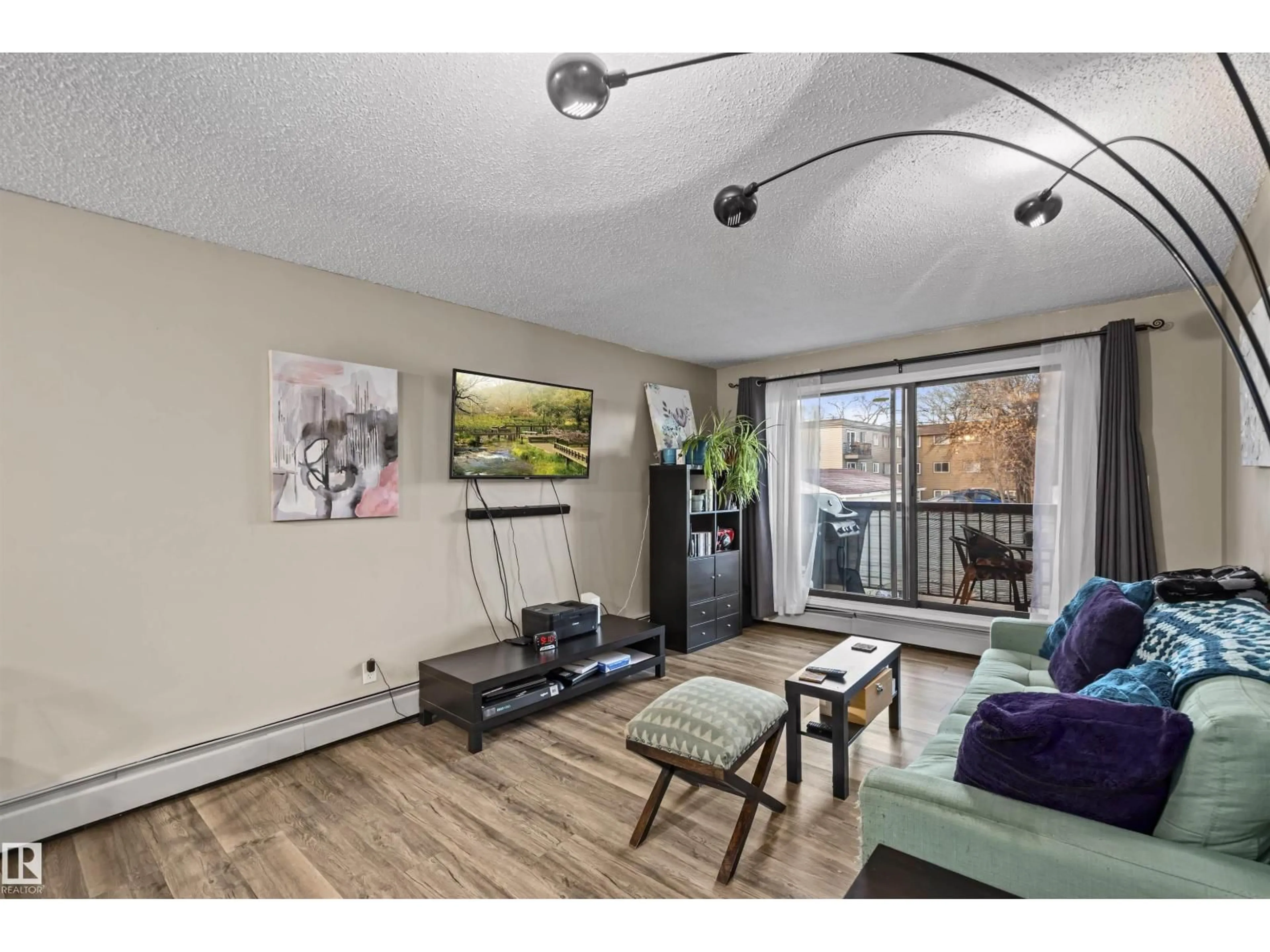 Living room with furniture, wood/laminate floor for 202 - 11040 82 ST, Edmonton Alberta T5H1L9