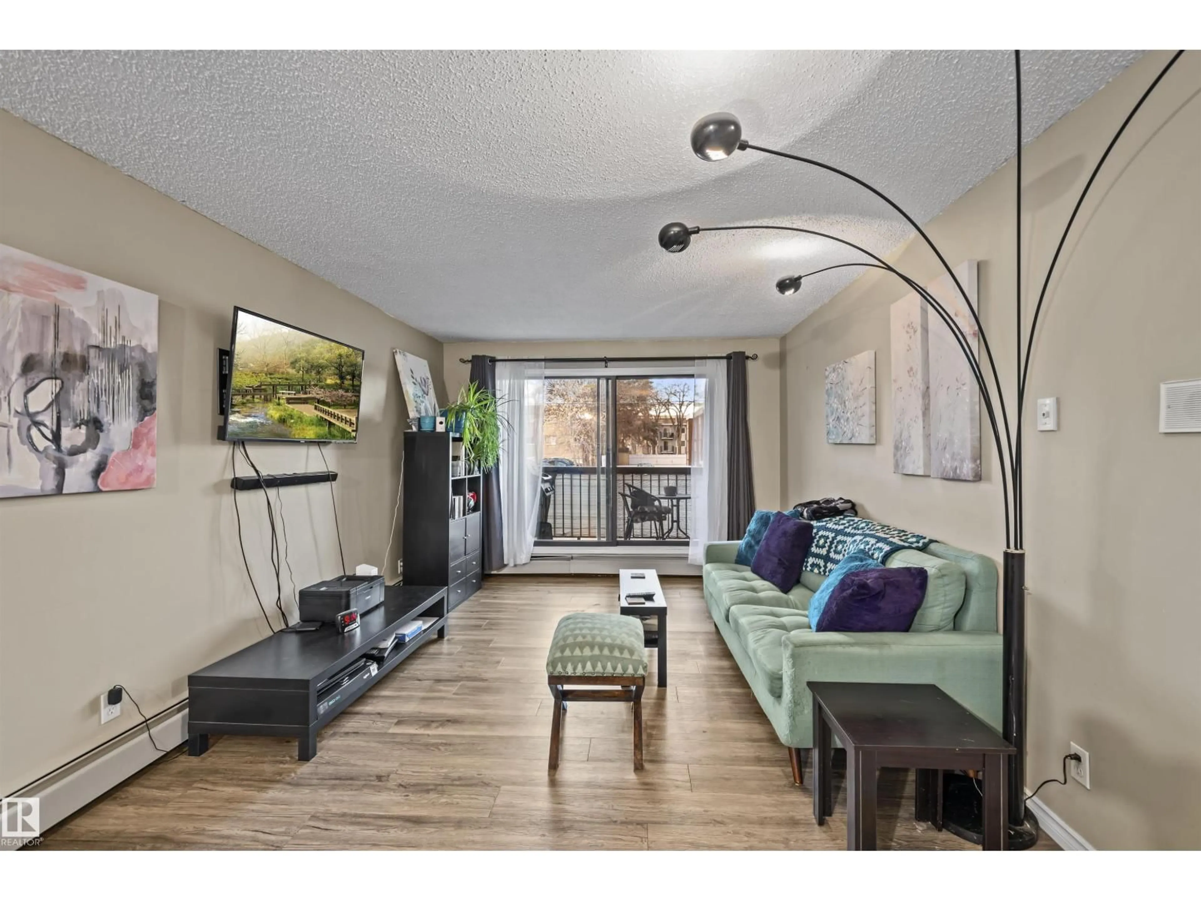 Living room with furniture, wood/laminate floor for 202 - 11040 82 ST, Edmonton Alberta T5H1L9