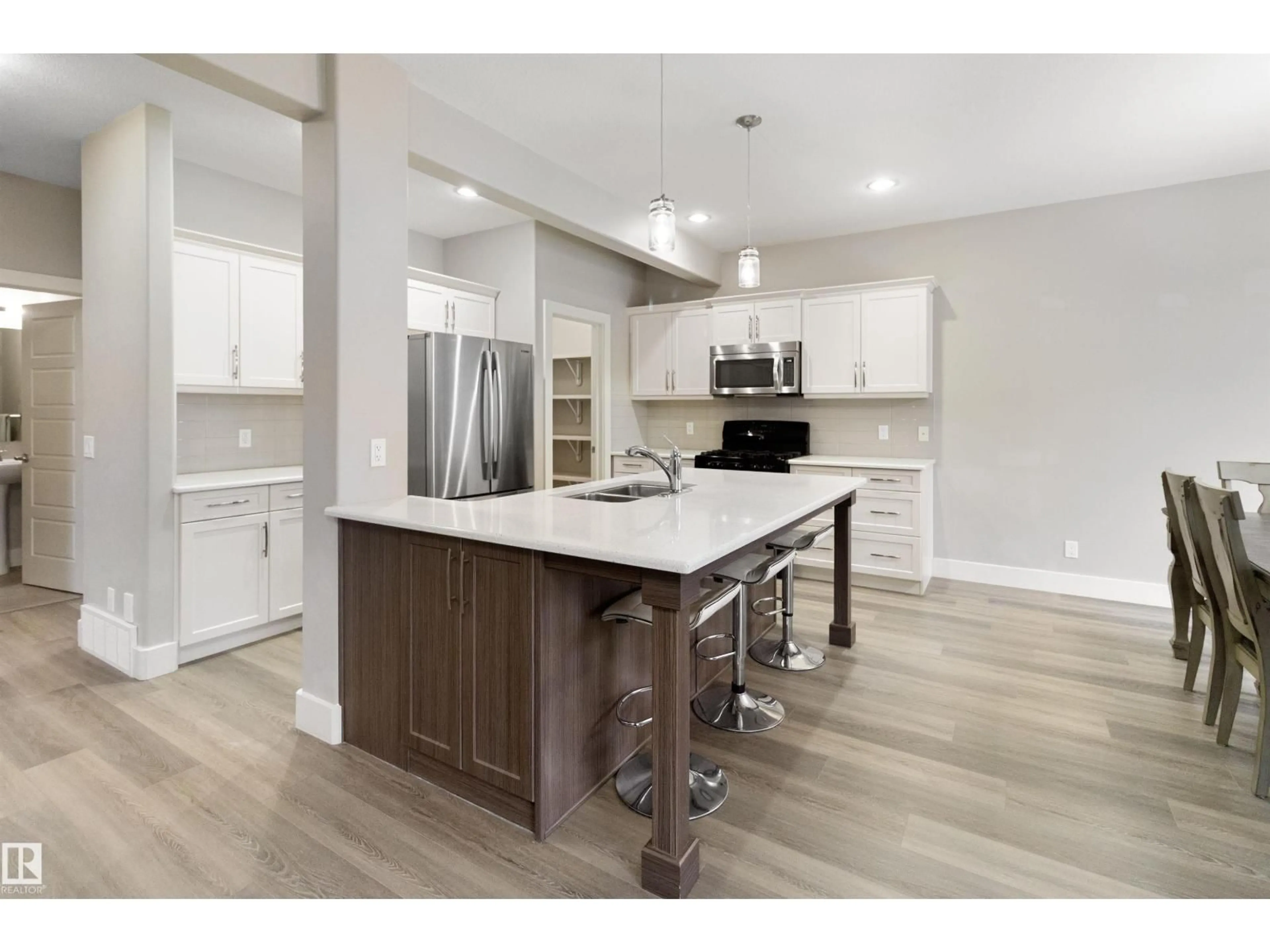 Open concept kitchen, wood/laminate floor for 110 WOODBRIDGE LI, Fort Saskatchewan Alberta T8L0H4
