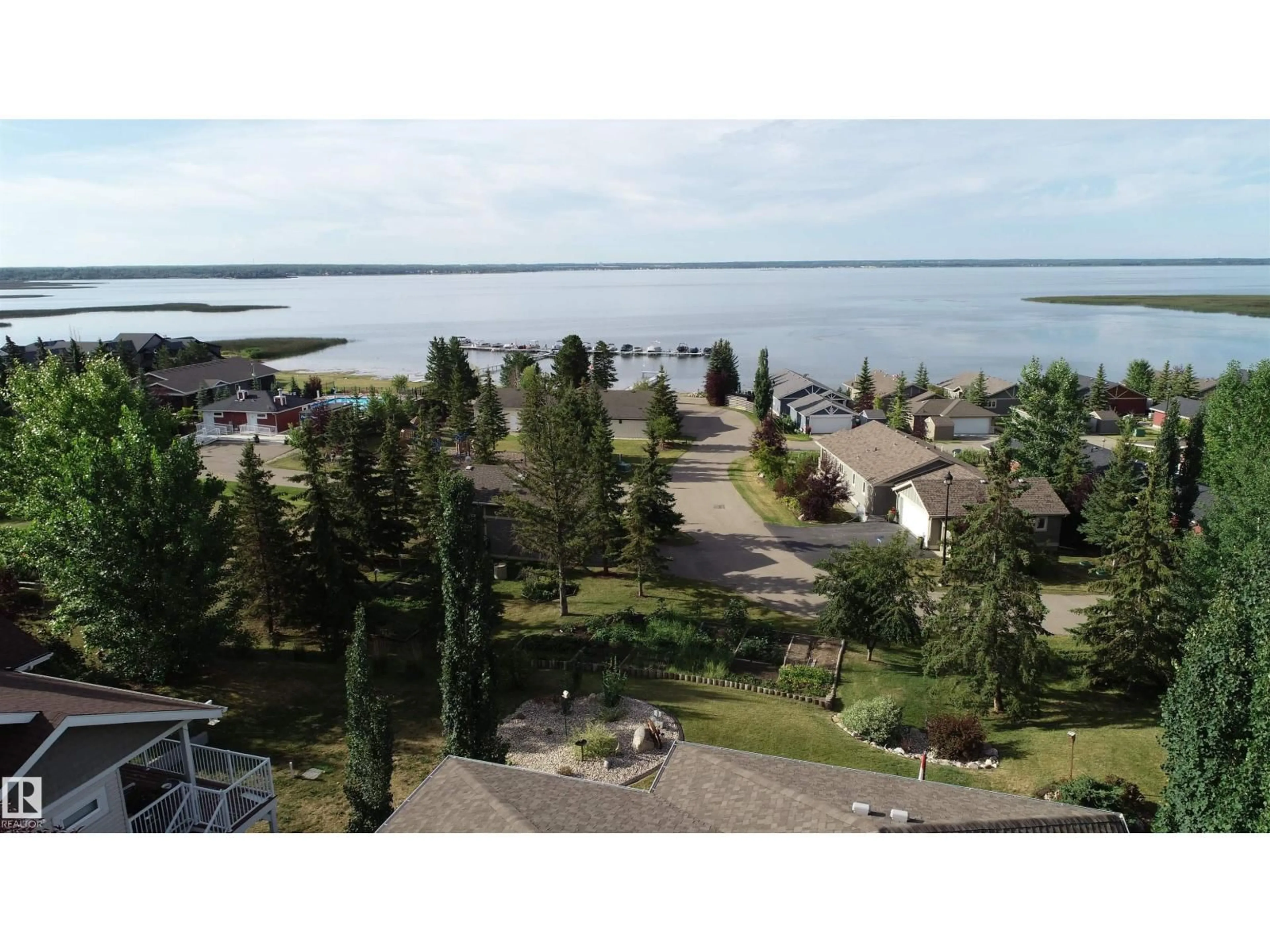 A pic from outside/outdoor area/front of a property/back of a property/a pic from drone, water/lake/river/ocean view for 55101 STE. ANNE TR, Rural Lac Ste. Anne County Alberta T0E1A1