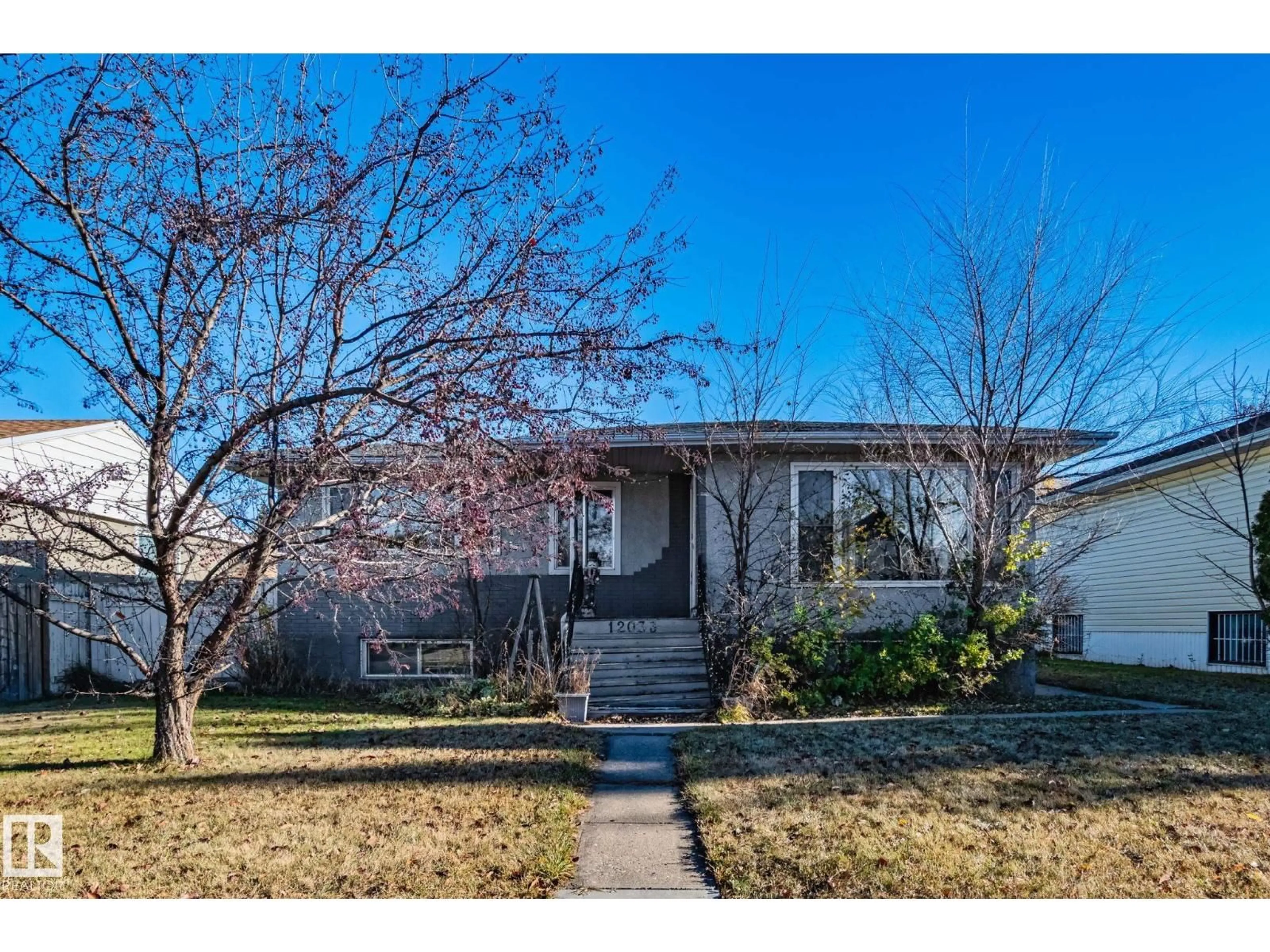 Home with vinyl exterior material, street for NW - 12033 54 ST, Edmonton Alberta T5W3N2