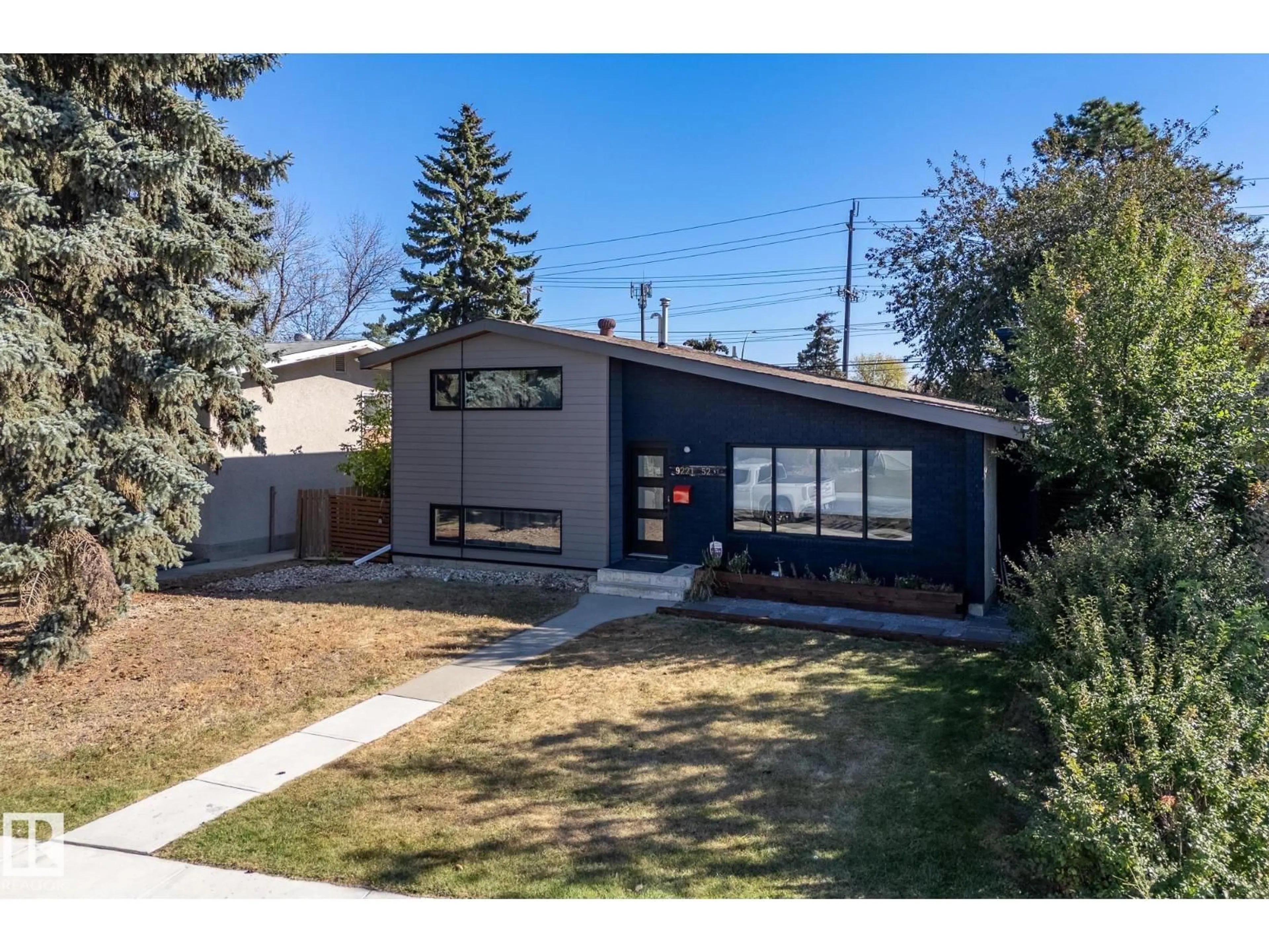 Home with vinyl exterior material, street for 9221 52 ST, Edmonton Alberta T6B1G3