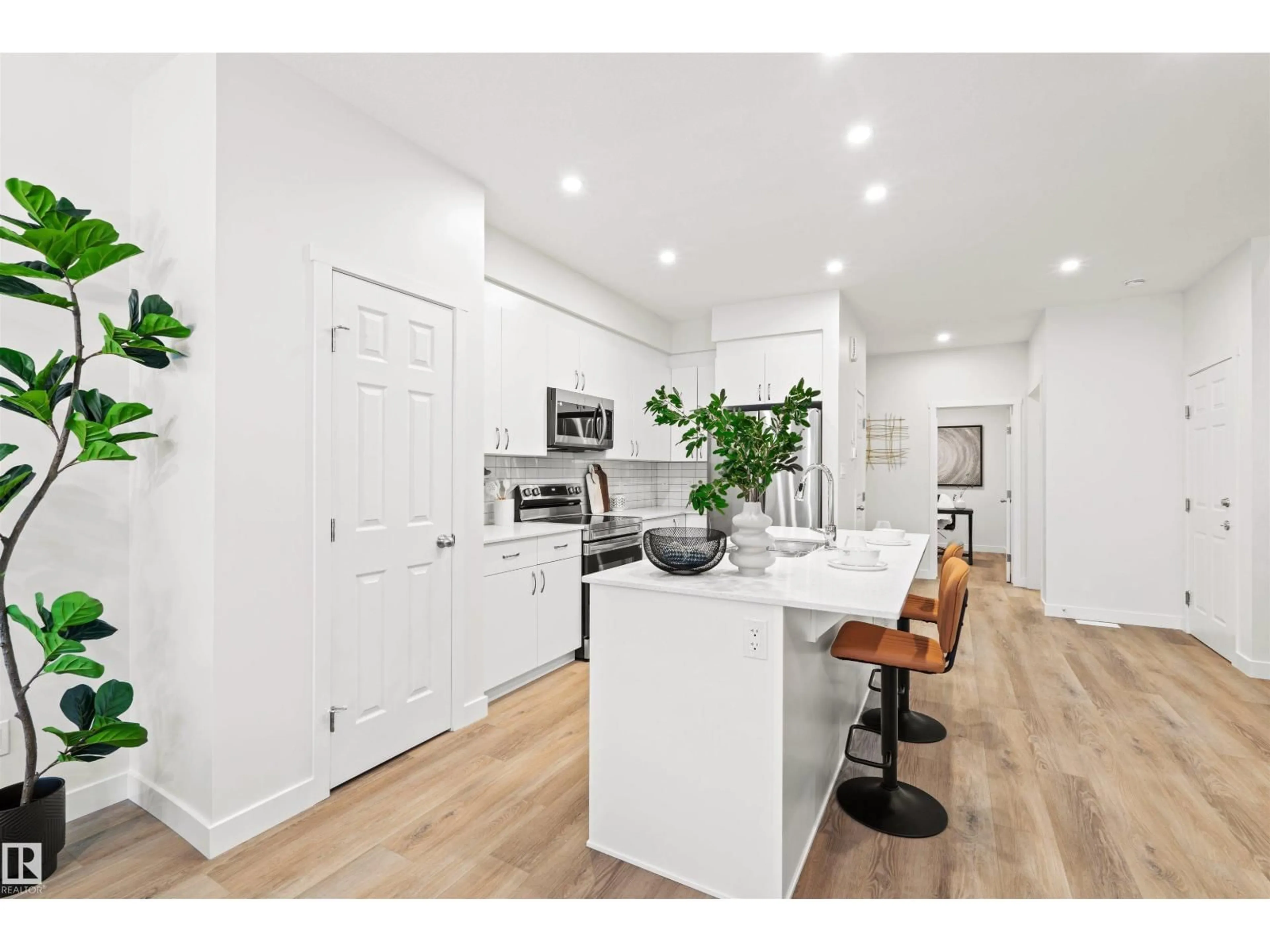 Open concept kitchen, wood/laminate floor for 2009 209A ST, Edmonton Alberta T6M3C8