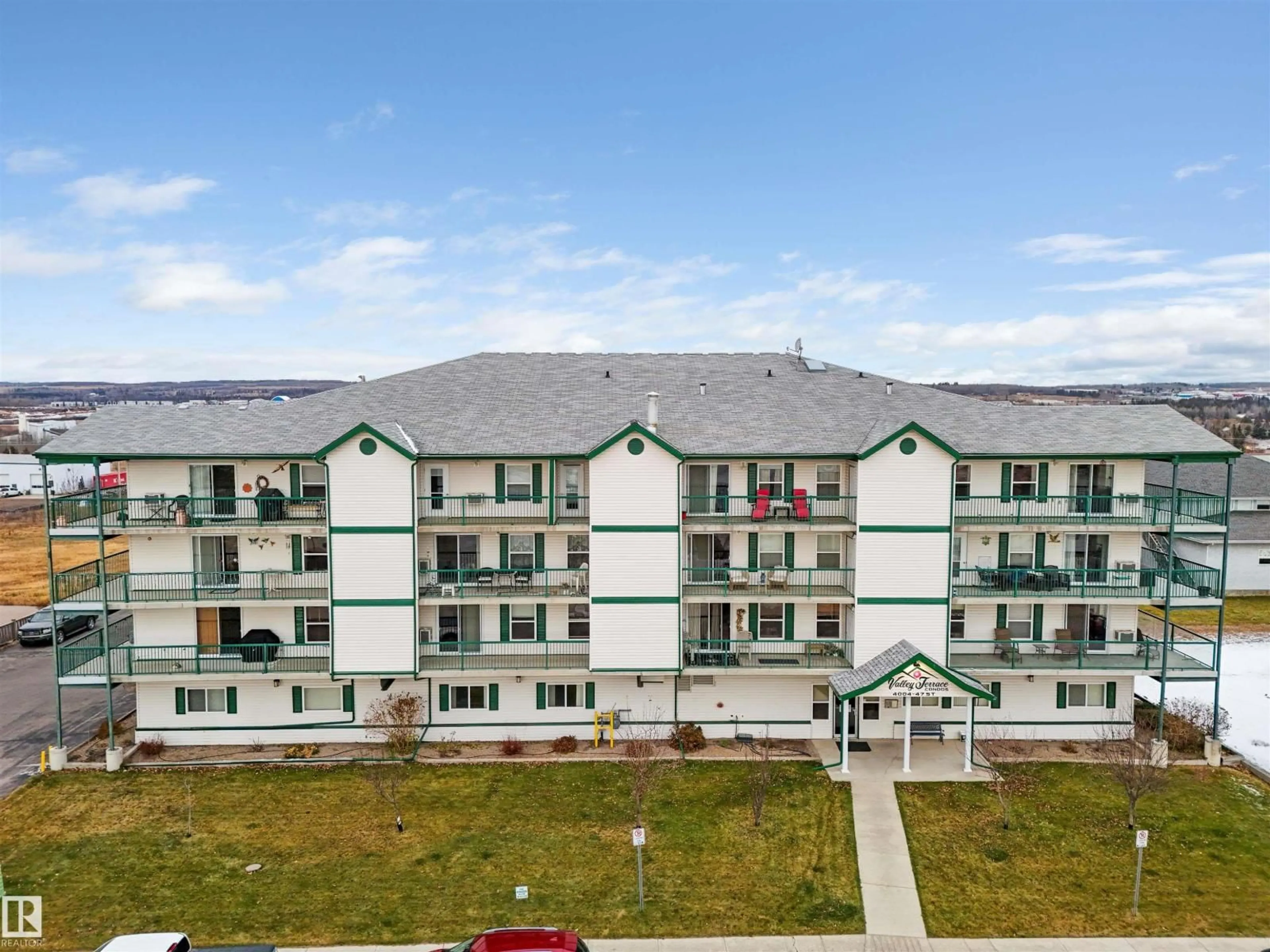 A pic from outside/outdoor area/front of a property/back of a property/a pic from drone, building for 202 - 4004 47 ST, Drayton Valley Alberta T7A0A2