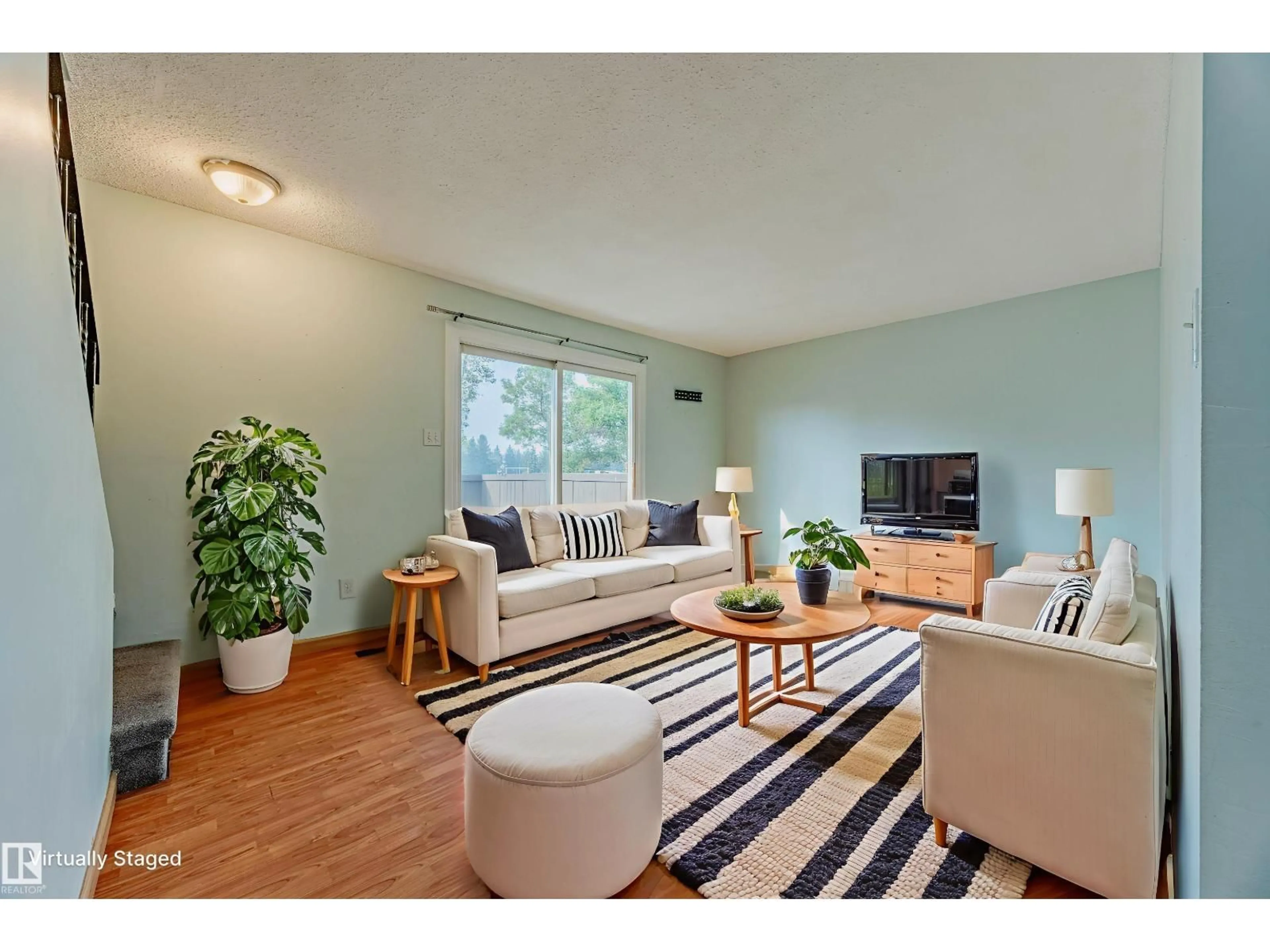 Living room with furniture, wood/laminate floor for NW - 2551 135 AV, Edmonton Alberta T5A3S5