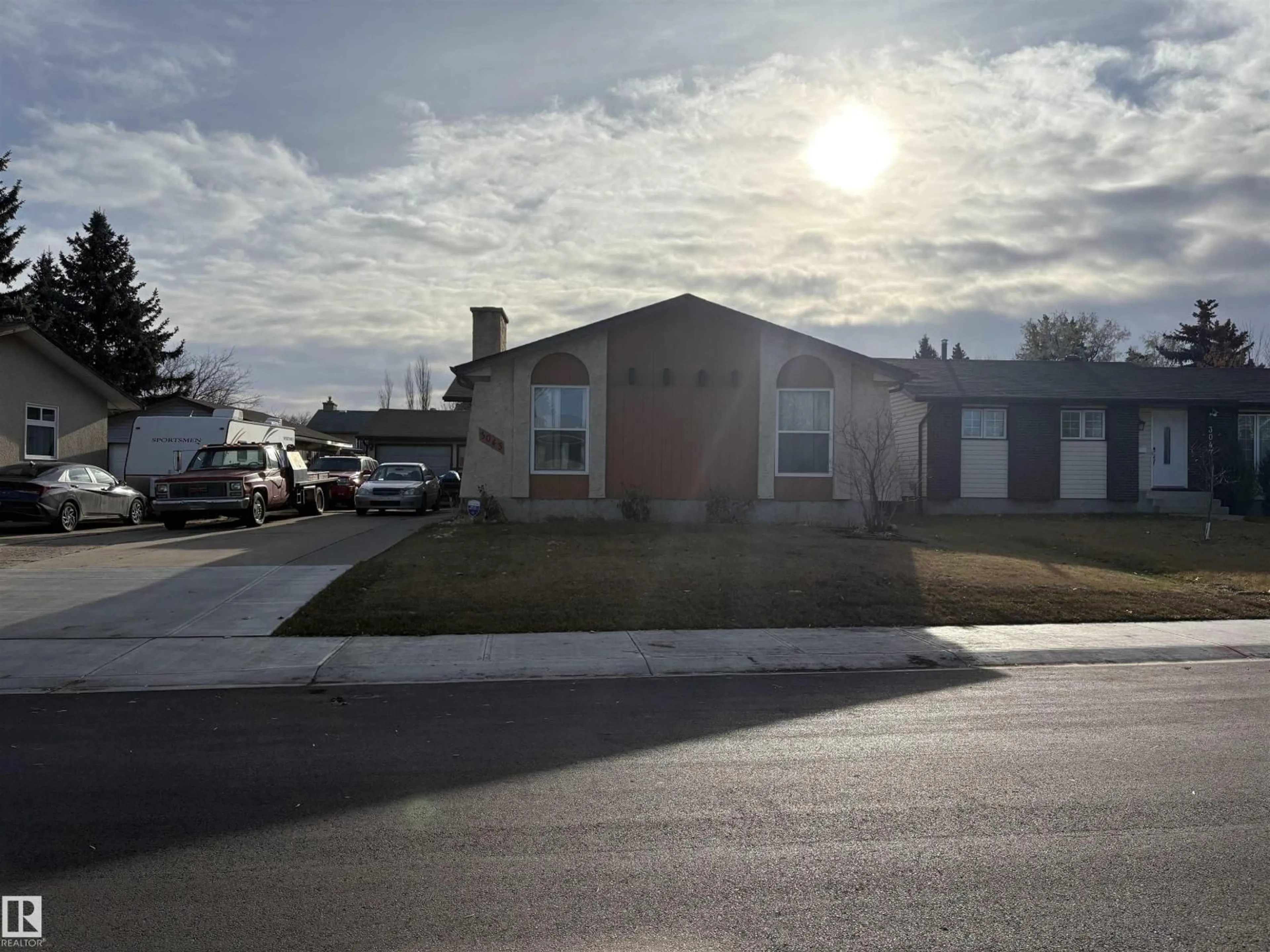 Home with vinyl exterior material, street for 3043 142 AV, Edmonton Alberta T5Y1J1