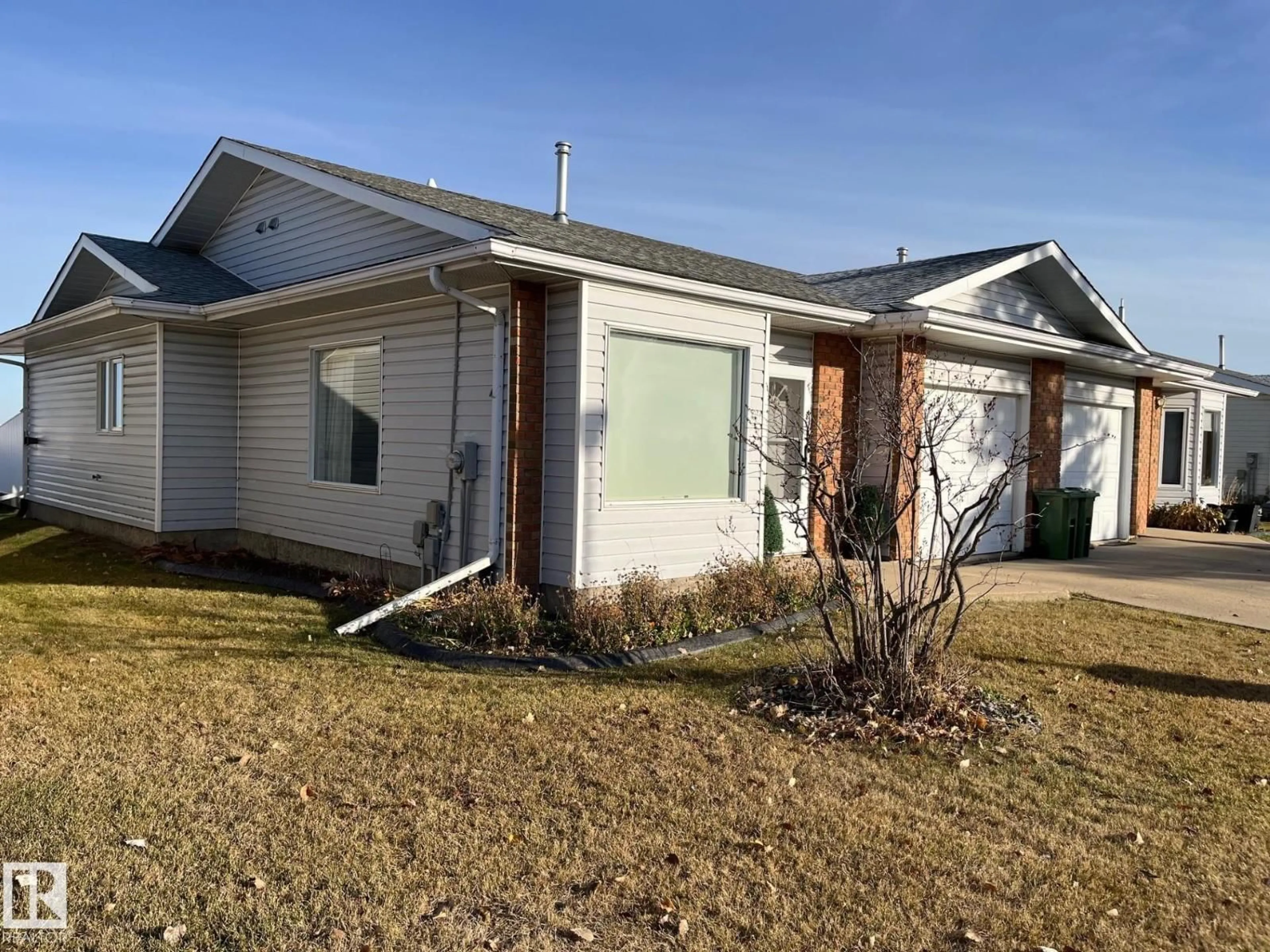 Home with vinyl exterior material, street for 32 11015 105 AV, Westlock Alberta T7P1A1