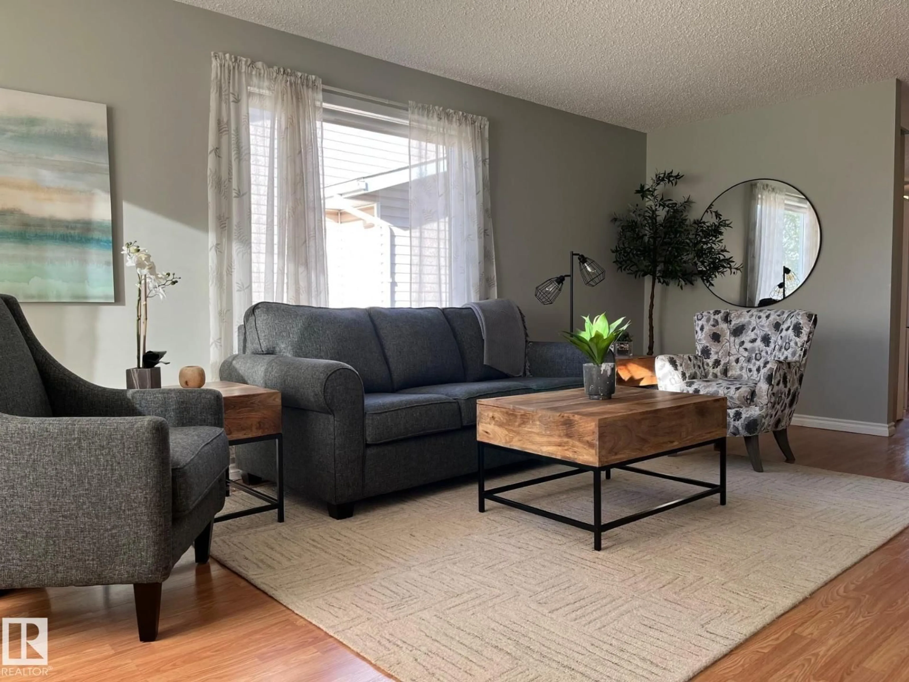 Living room with furniture, wood/laminate floor for 32 11015 105 AV, Westlock Alberta T7P1A1