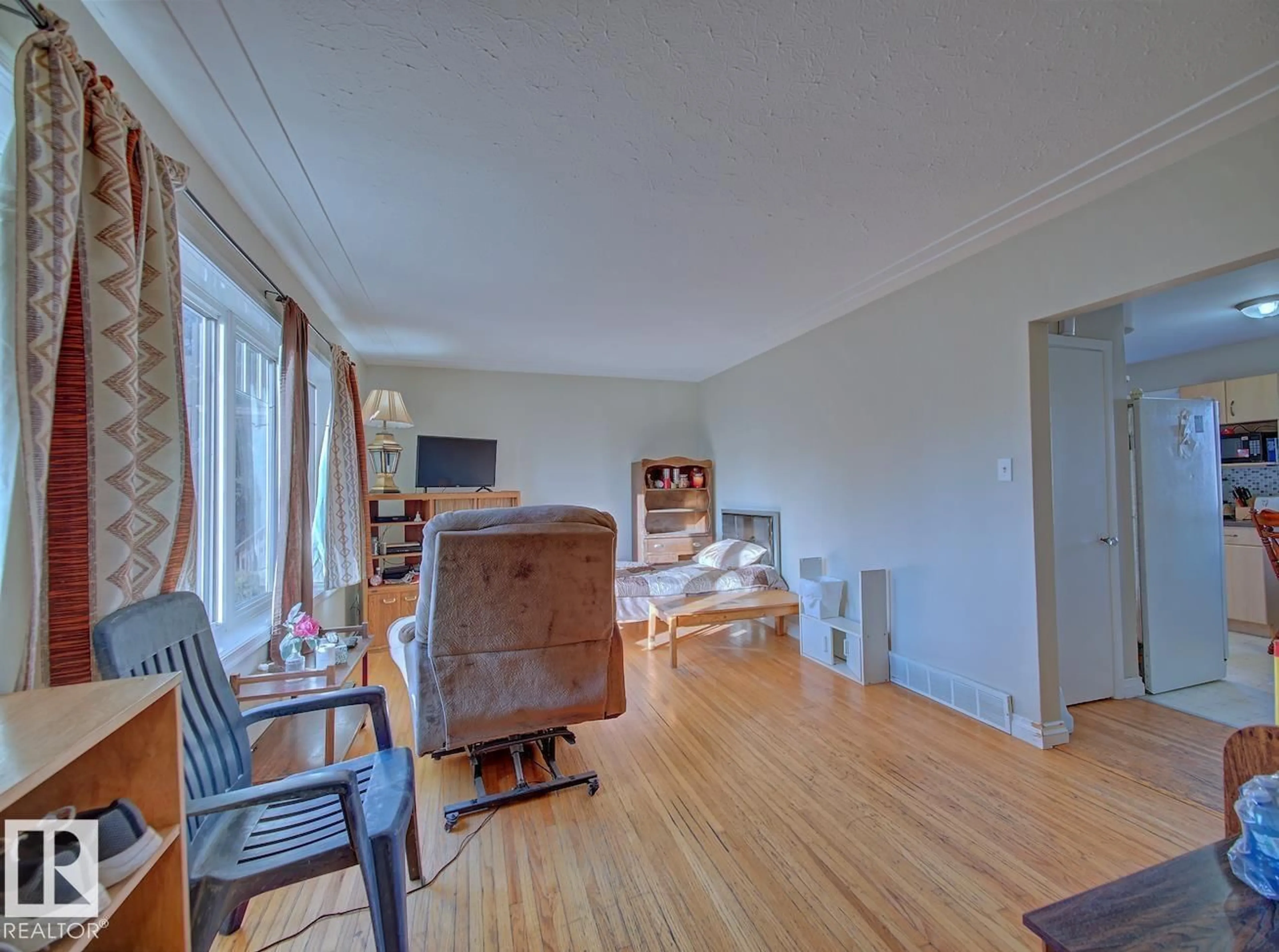 Living room with furniture, unknown for 7908 82 AV, Edmonton Alberta T6C0Y0