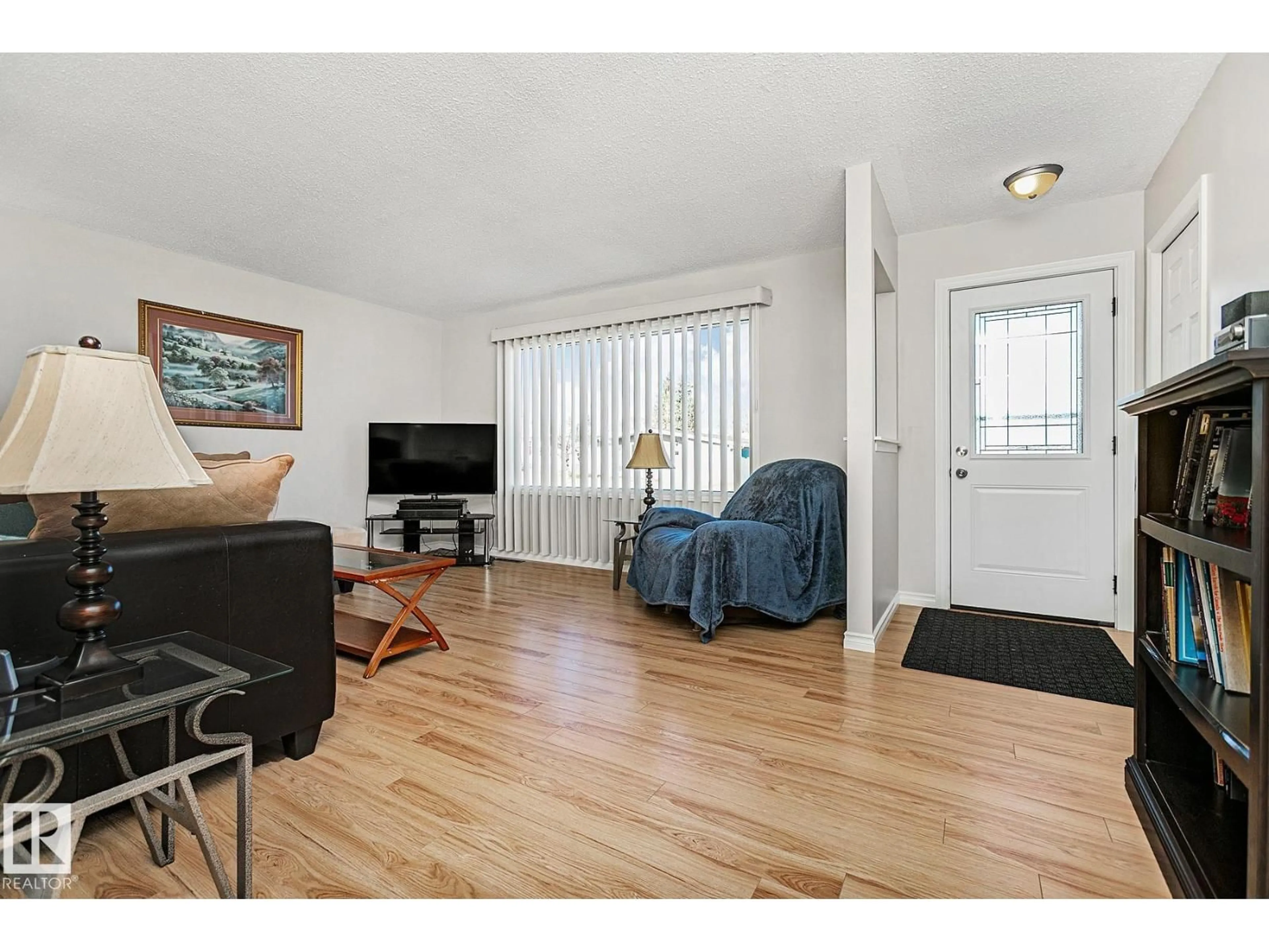 Living room with furniture, wood/laminate floor for 6315 132A AV, Edmonton Alberta T5A0J9