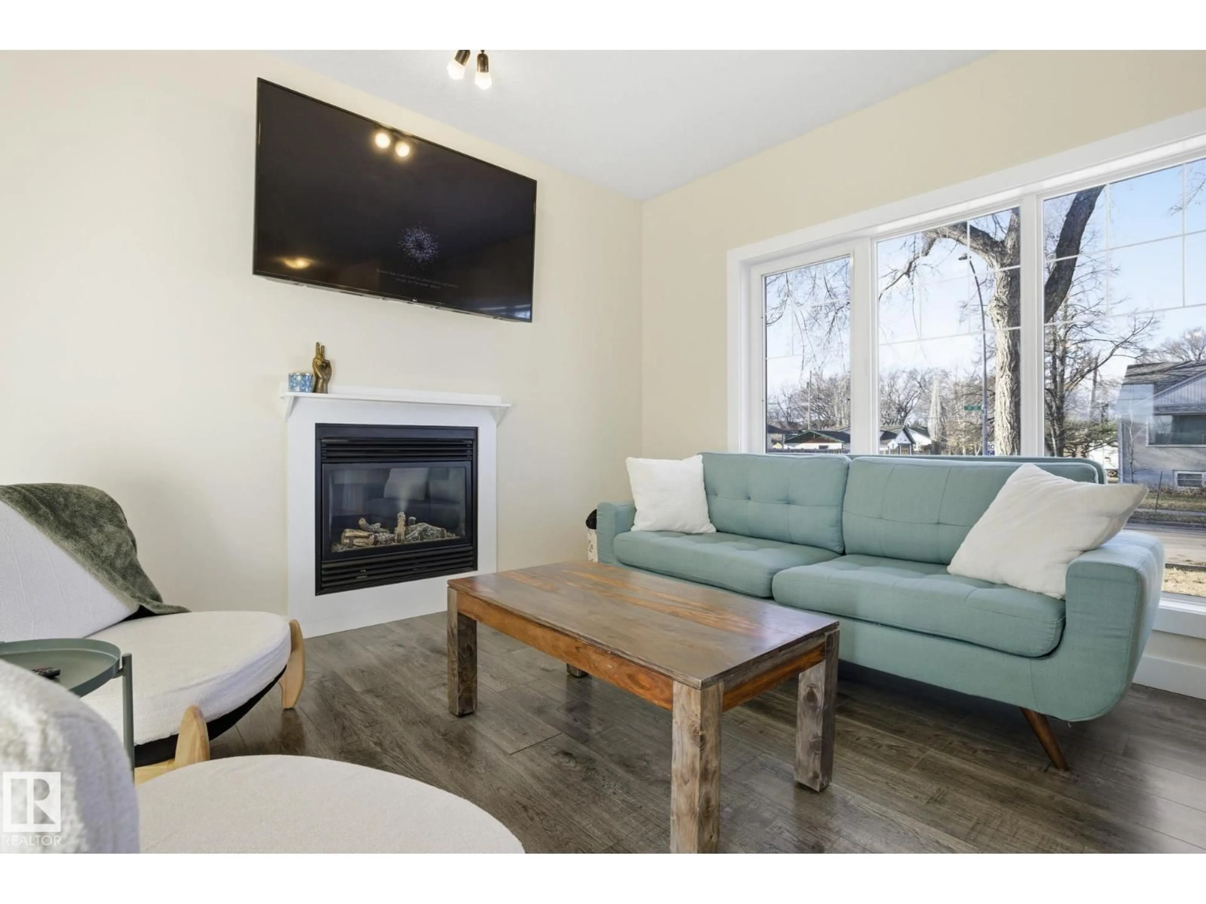 Living room with furniture, wood/laminate floor for 11903 51 ST, Edmonton Alberta T5W3G5