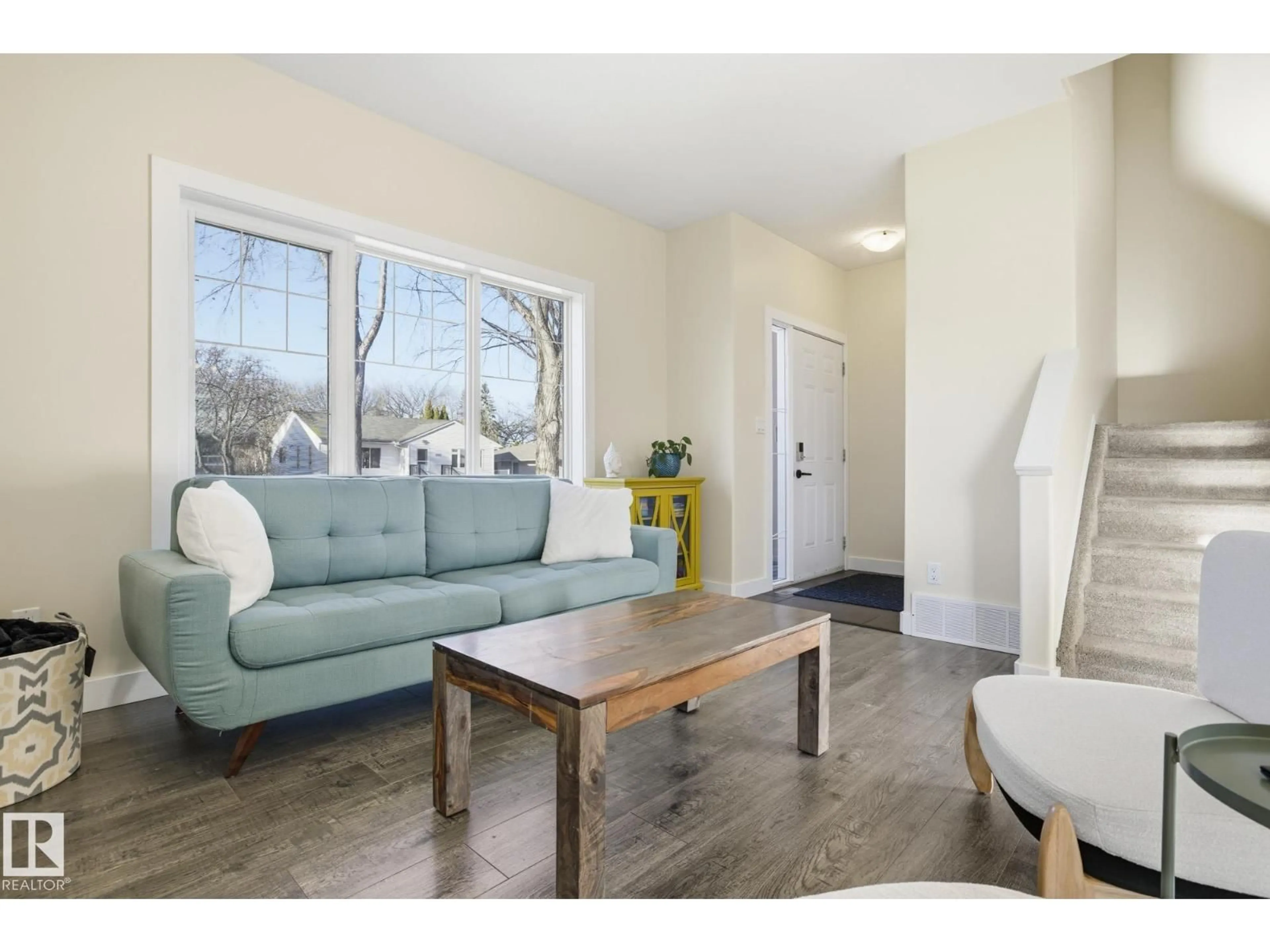 Living room with furniture, wood/laminate floor for 11903 51 ST, Edmonton Alberta T5W3G5