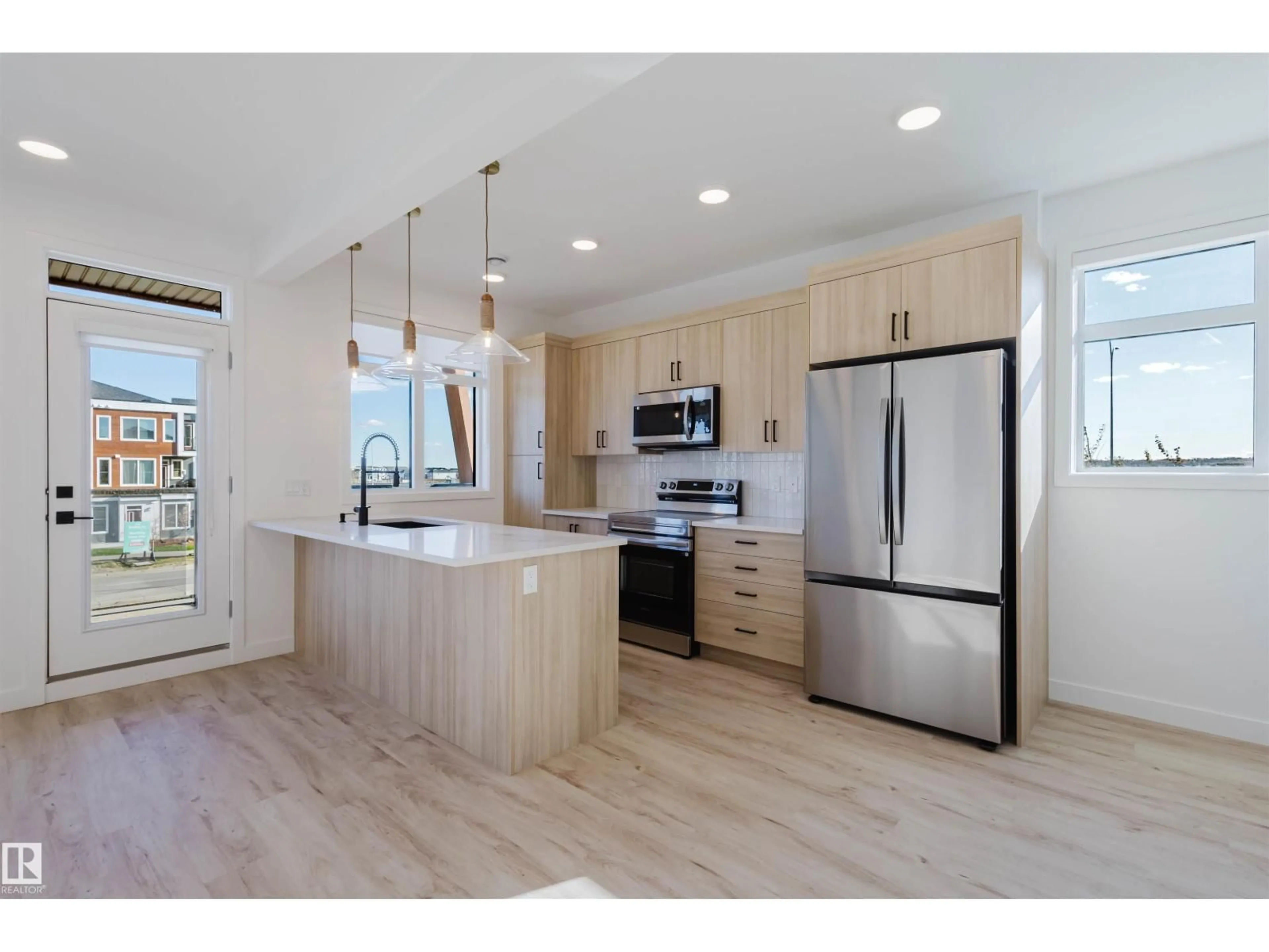 Open concept kitchen, wood/laminate floor for #23 - 16231 19 AV, Edmonton Alberta T6W5C6