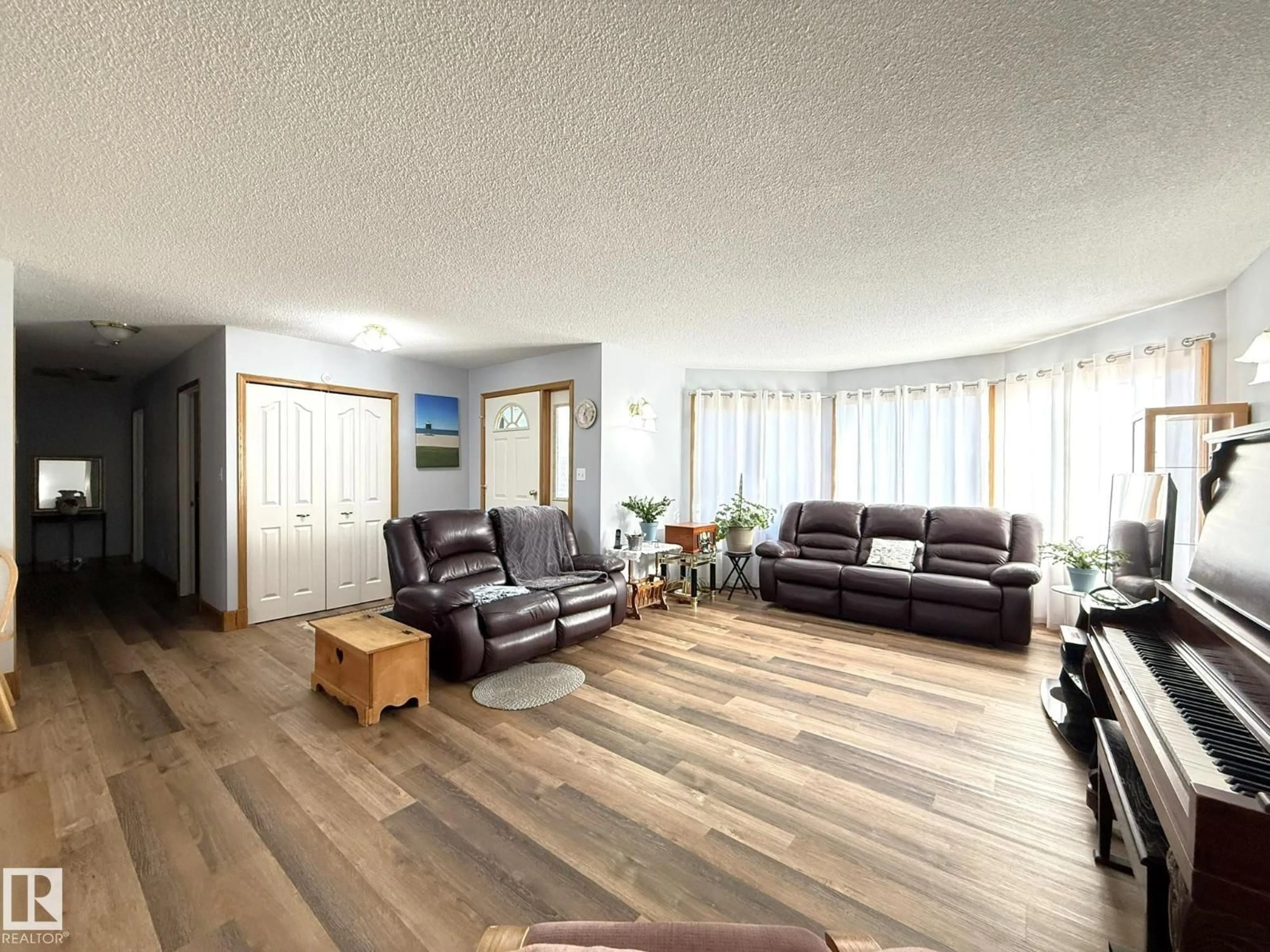 Living room with furniture, wood/laminate floor for 148 WILLOW DR, Breton Alberta T0C0P0
