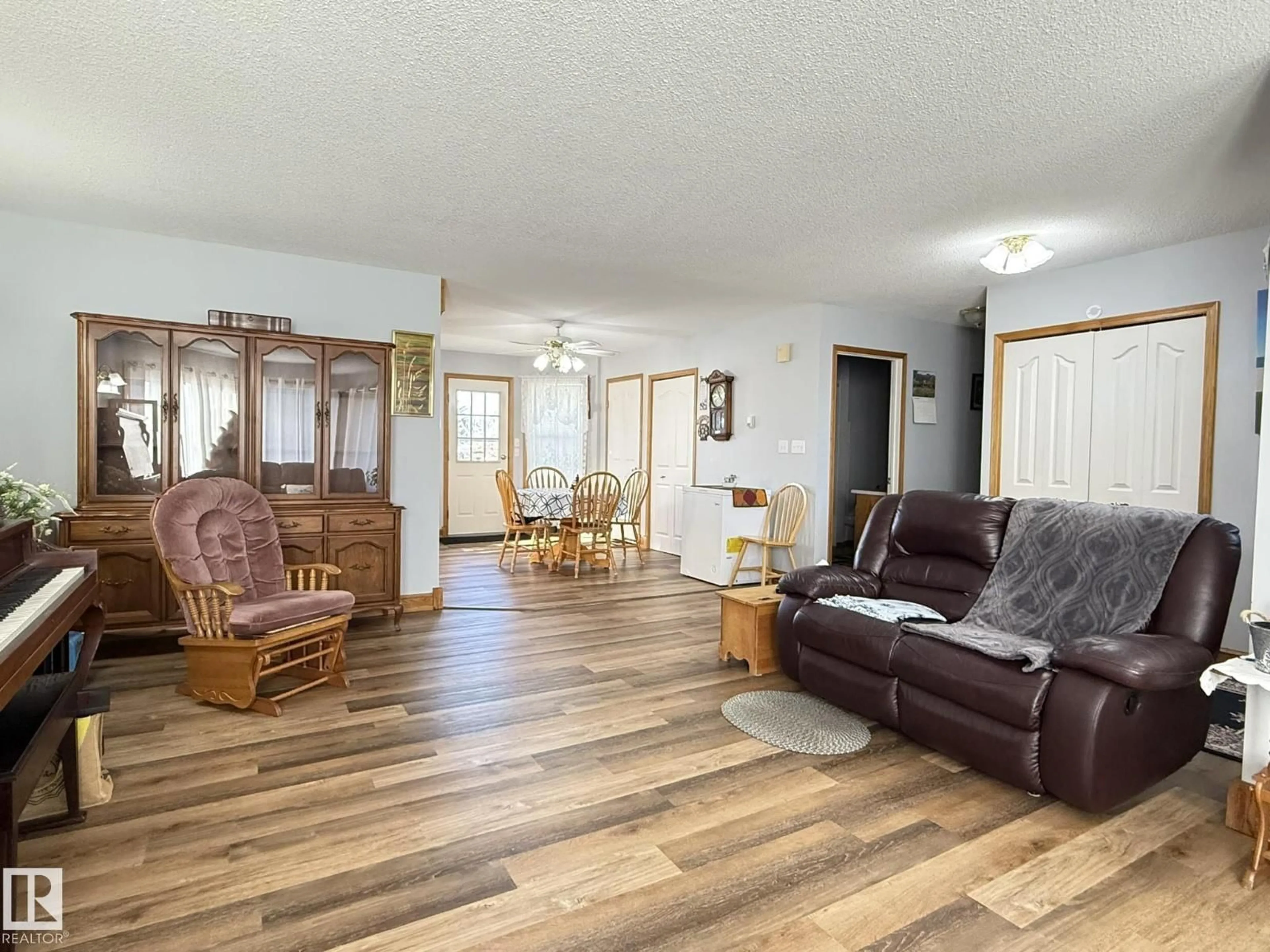 Living room with furniture, wood/laminate floor for 148 WILLOW DR, Breton Alberta T0C0P0