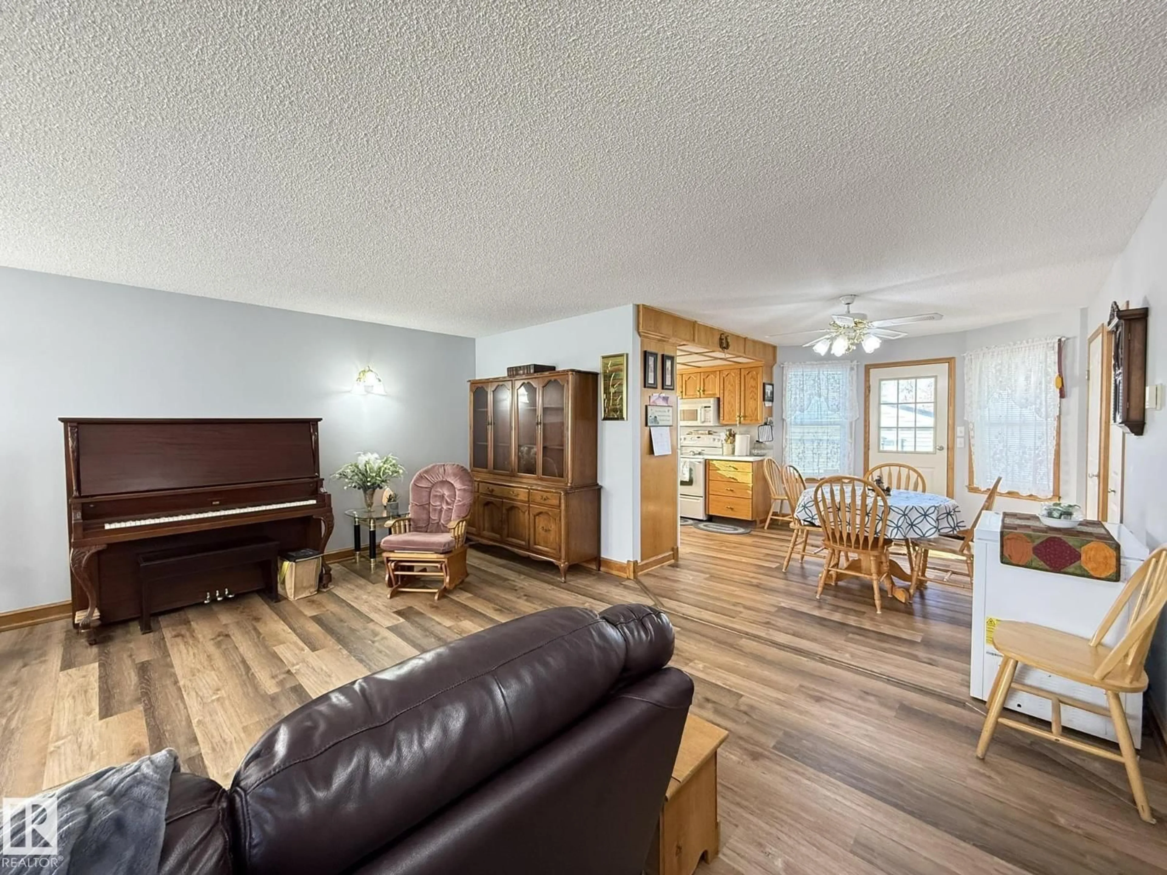 Living room with furniture, wood/laminate floor for 148 WILLOW DR, Breton Alberta T0C0P0