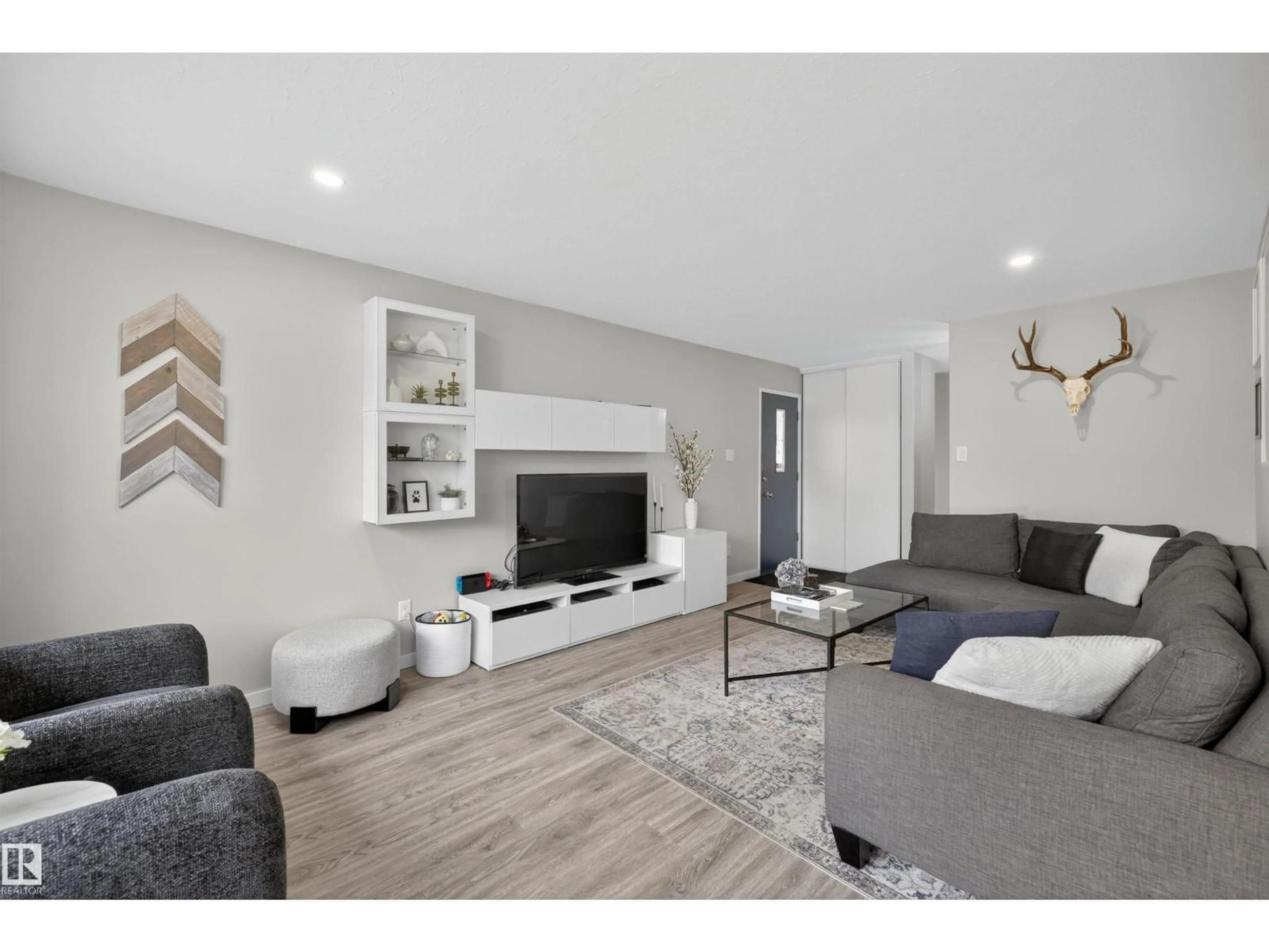 Living room with furniture, wood/laminate floor for 7719 71 AV, Edmonton Alberta T6C0A9