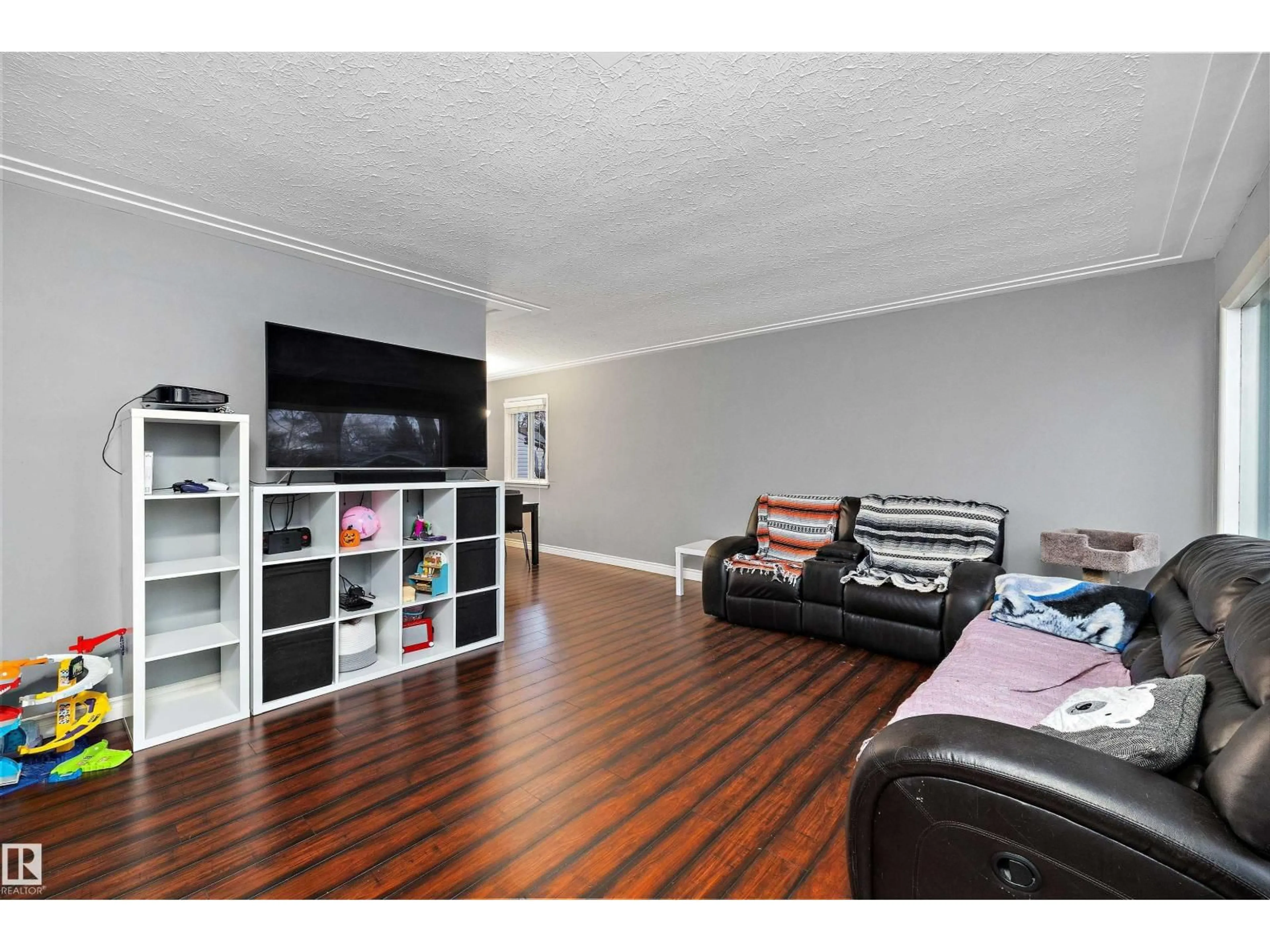 Living room with furniture, wood/laminate floor for 12039 52 ST, Edmonton Alberta T5W3J7