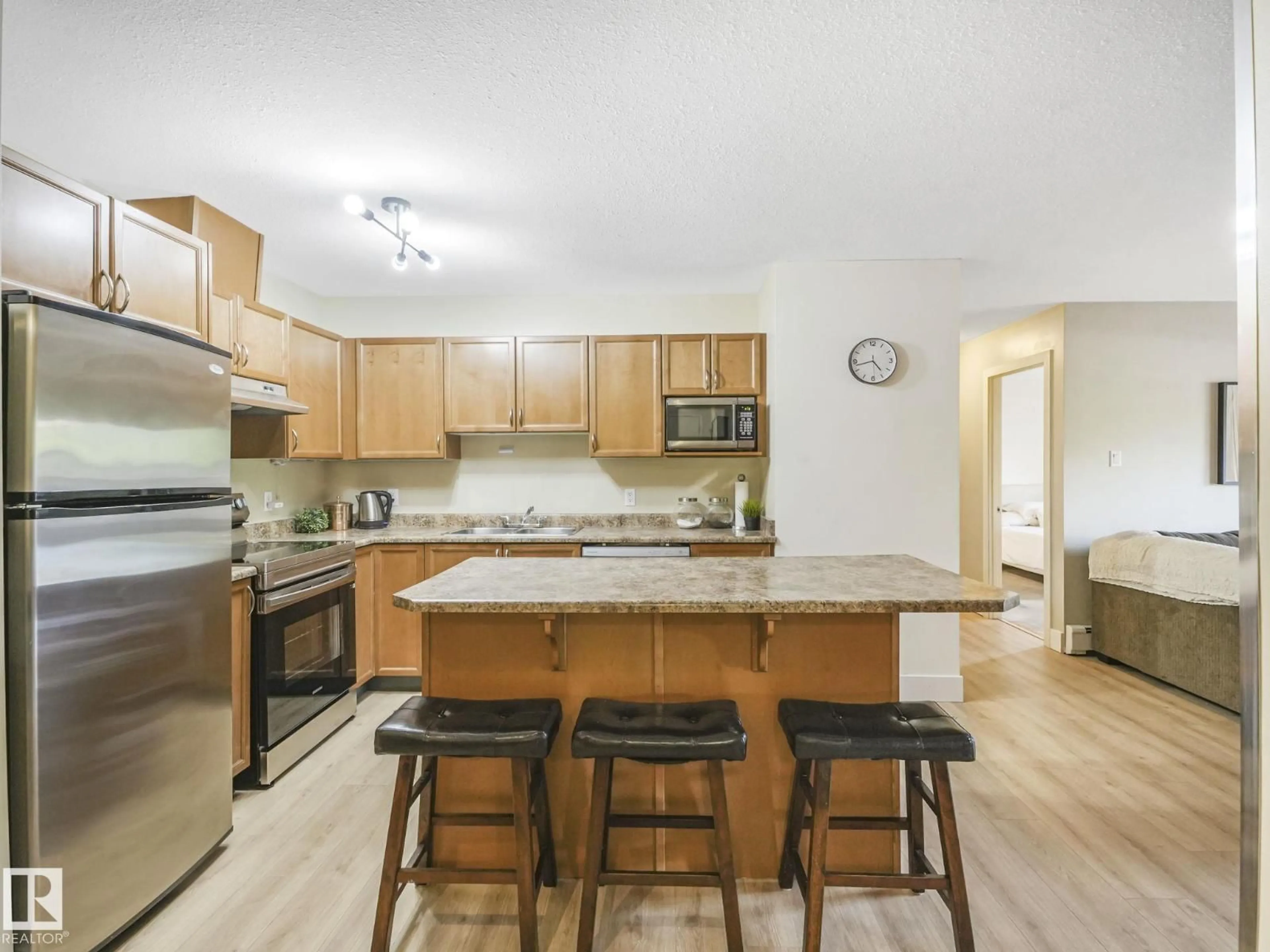 Open concept kitchen, wood/laminate floor for #102 - 9715 110 ST, Edmonton Alberta T5K2M1