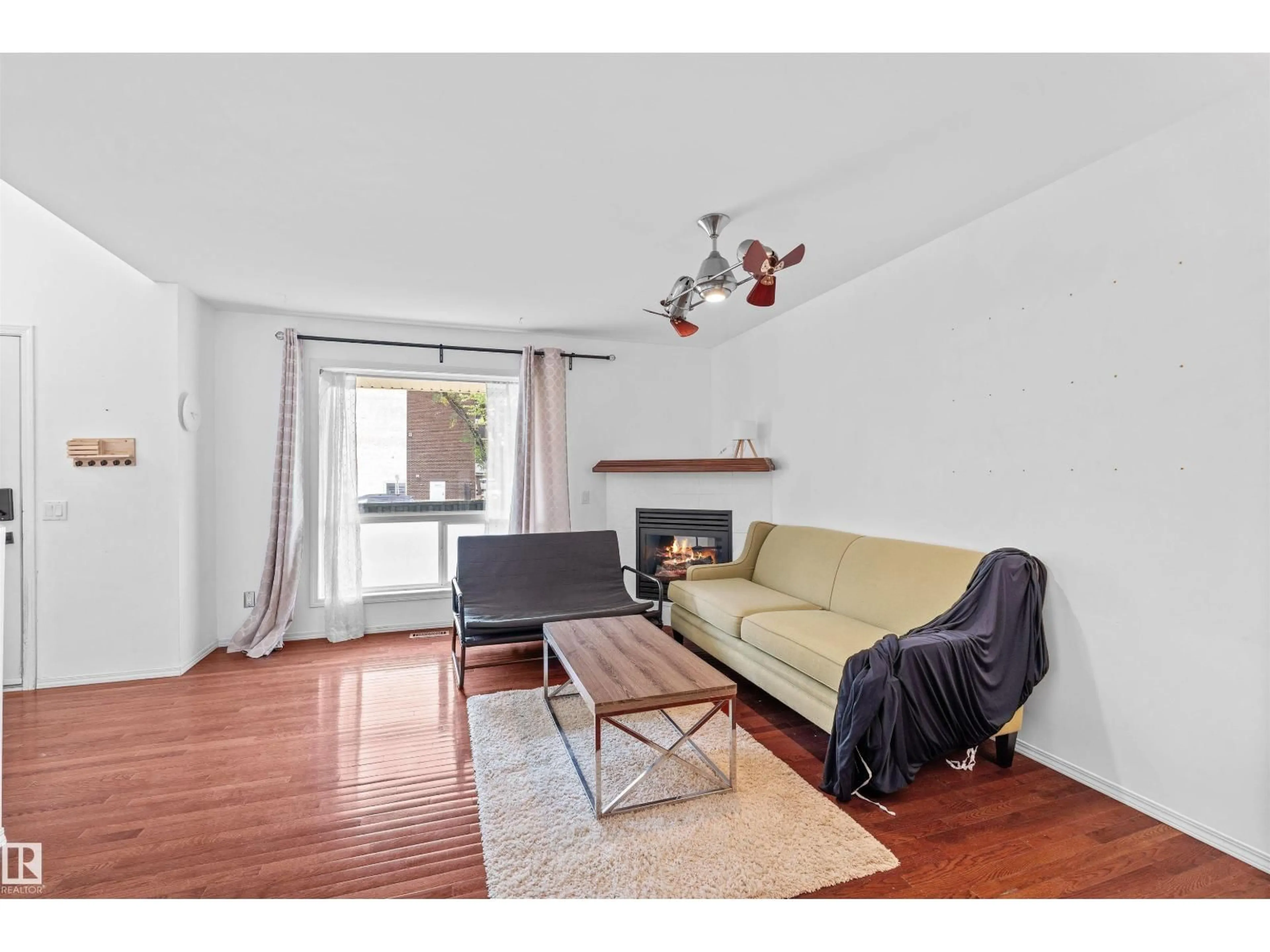 Living room with furniture, wood/laminate floor for 10516 108 AV, Edmonton Alberta T5H4M8