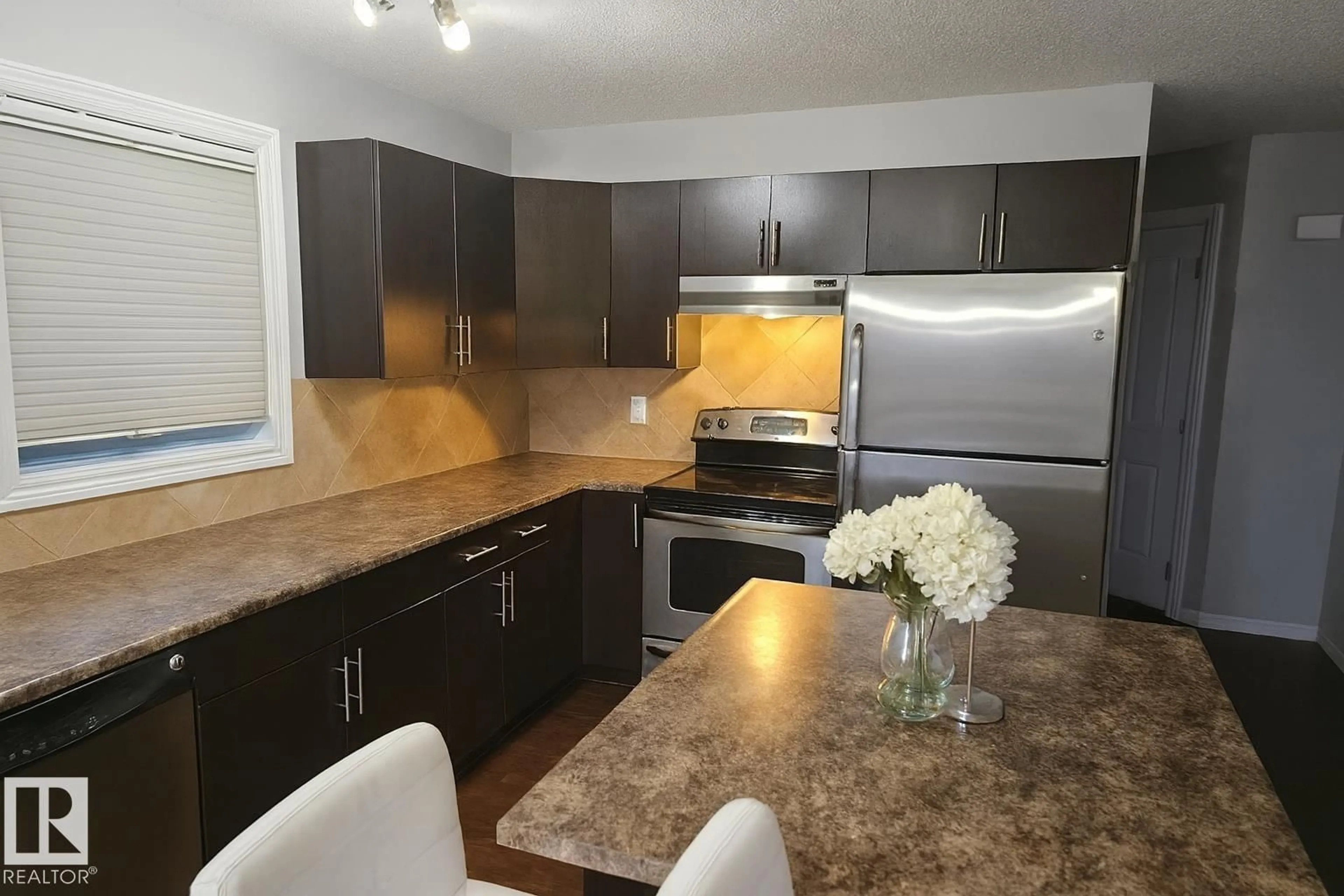 Open concept kitchen, wood/laminate floor for SW - 5144 1A AV, Edmonton Alberta T6X0X3