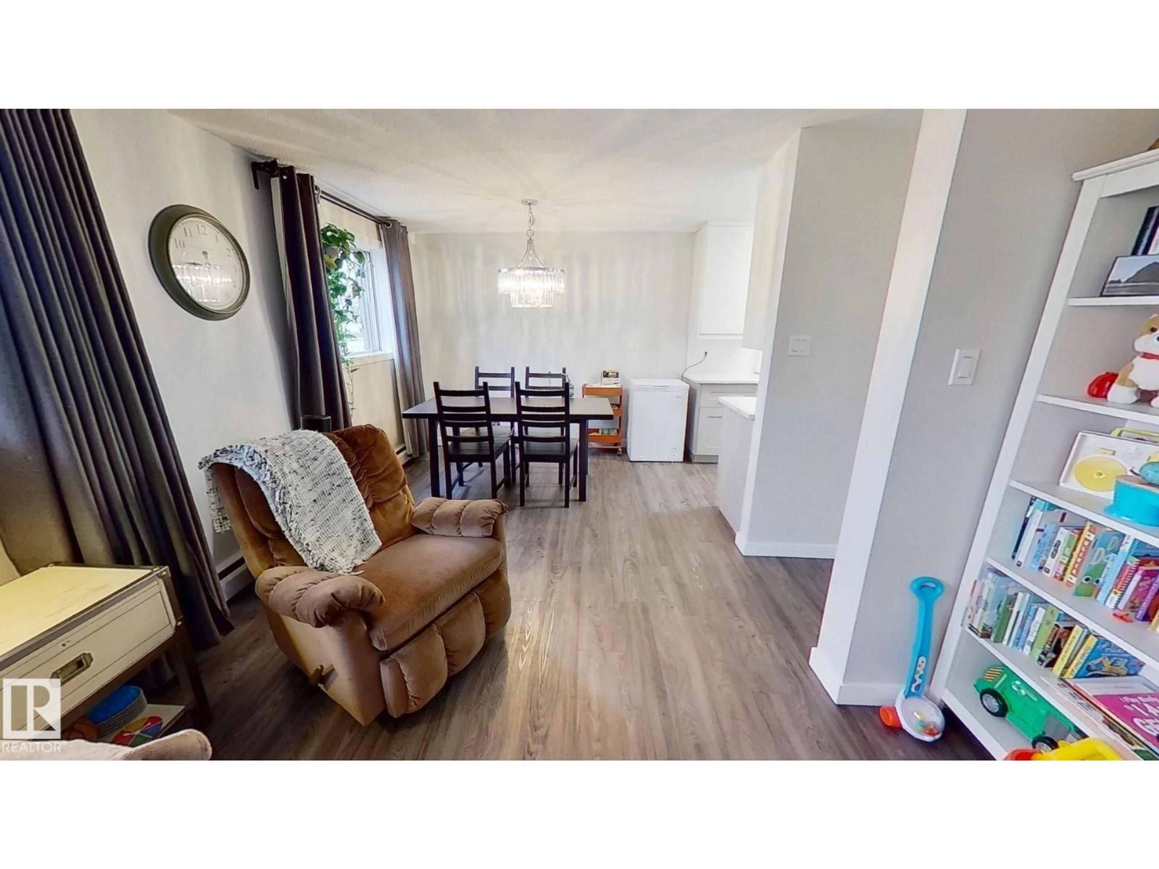 Living room with furniture, wood/laminate floor for 15930 109 AV, Edmonton Alberta T5P1B7