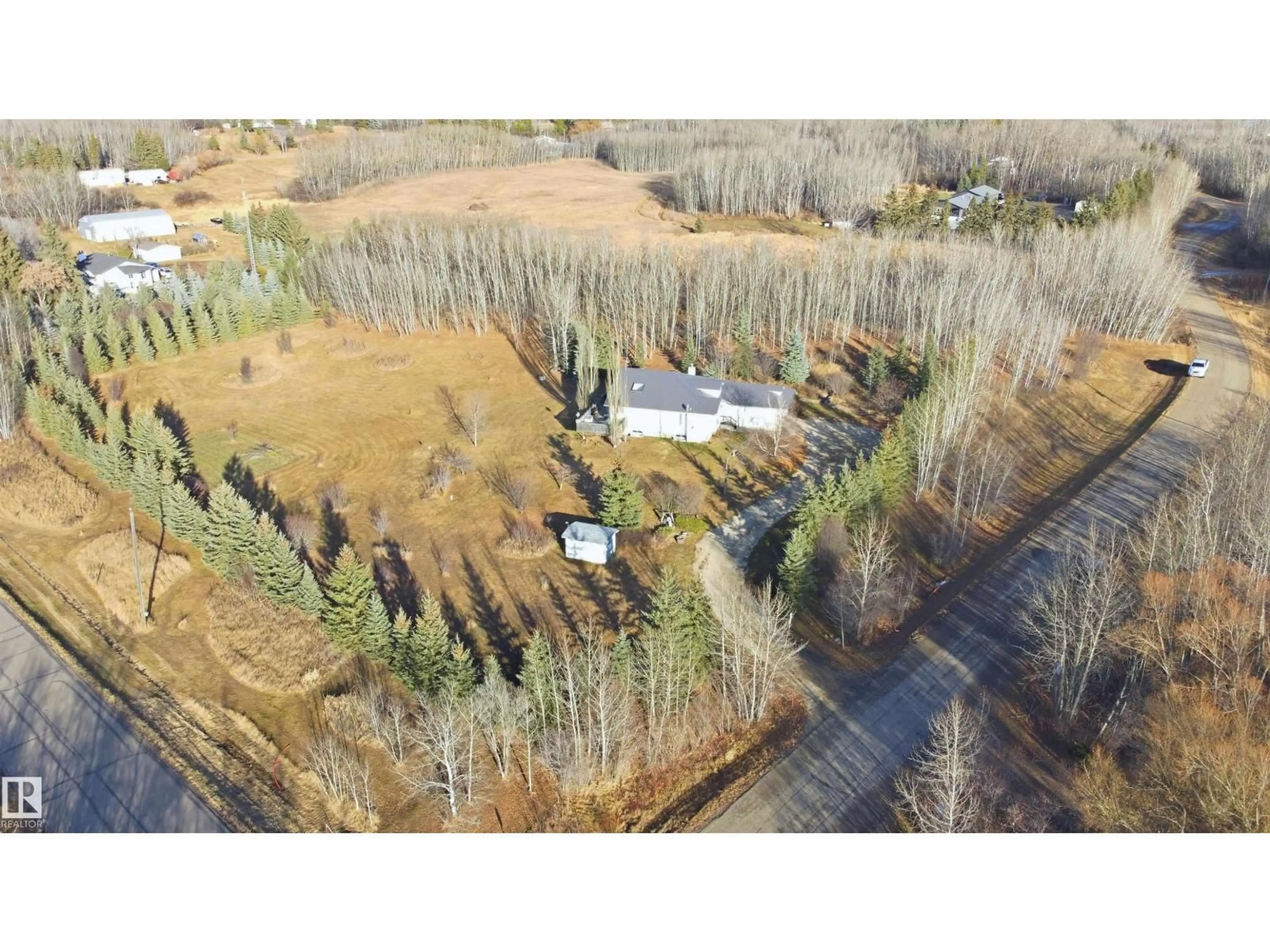 A pic from outside/outdoor area/front of a property/back of a property/a pic from drone, forest/trees view for 370 - 50247 RGE RD 232, Rural Leduc County Alberta T4X0K9