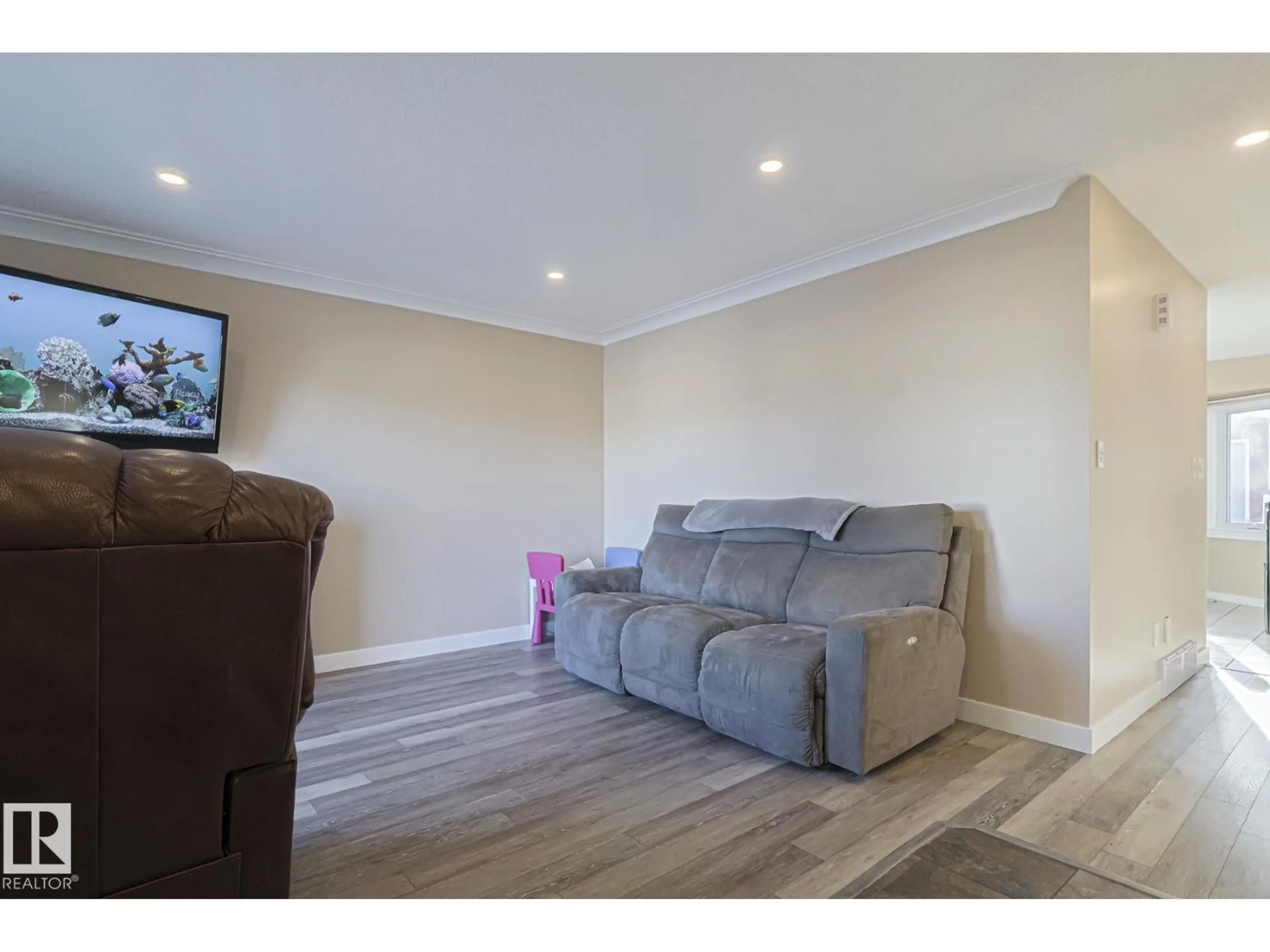 Living room with furniture, wood/laminate floor for 4211 30 AV, Edmonton Alberta T6L4P1