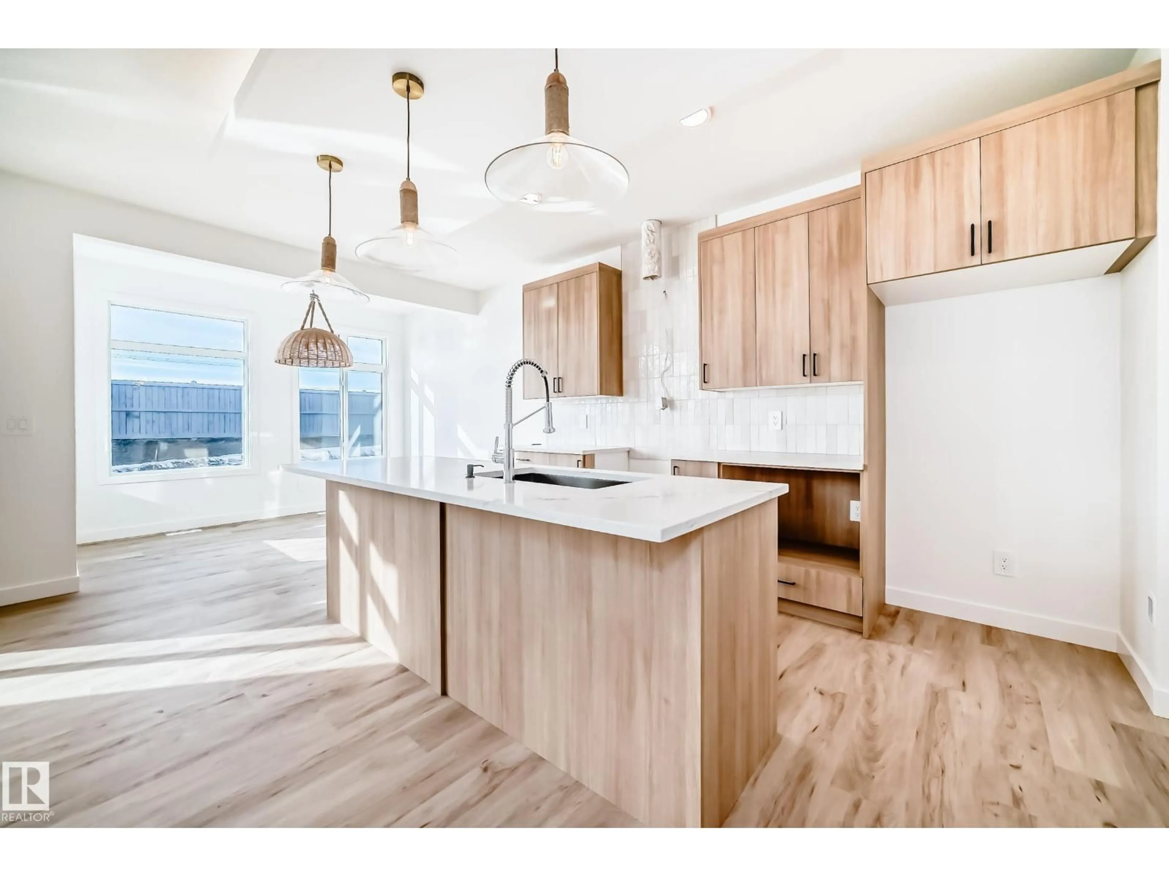 Open concept kitchen, wood/laminate floor for SW - 6315 27 AV, Edmonton Alberta T6W5S2