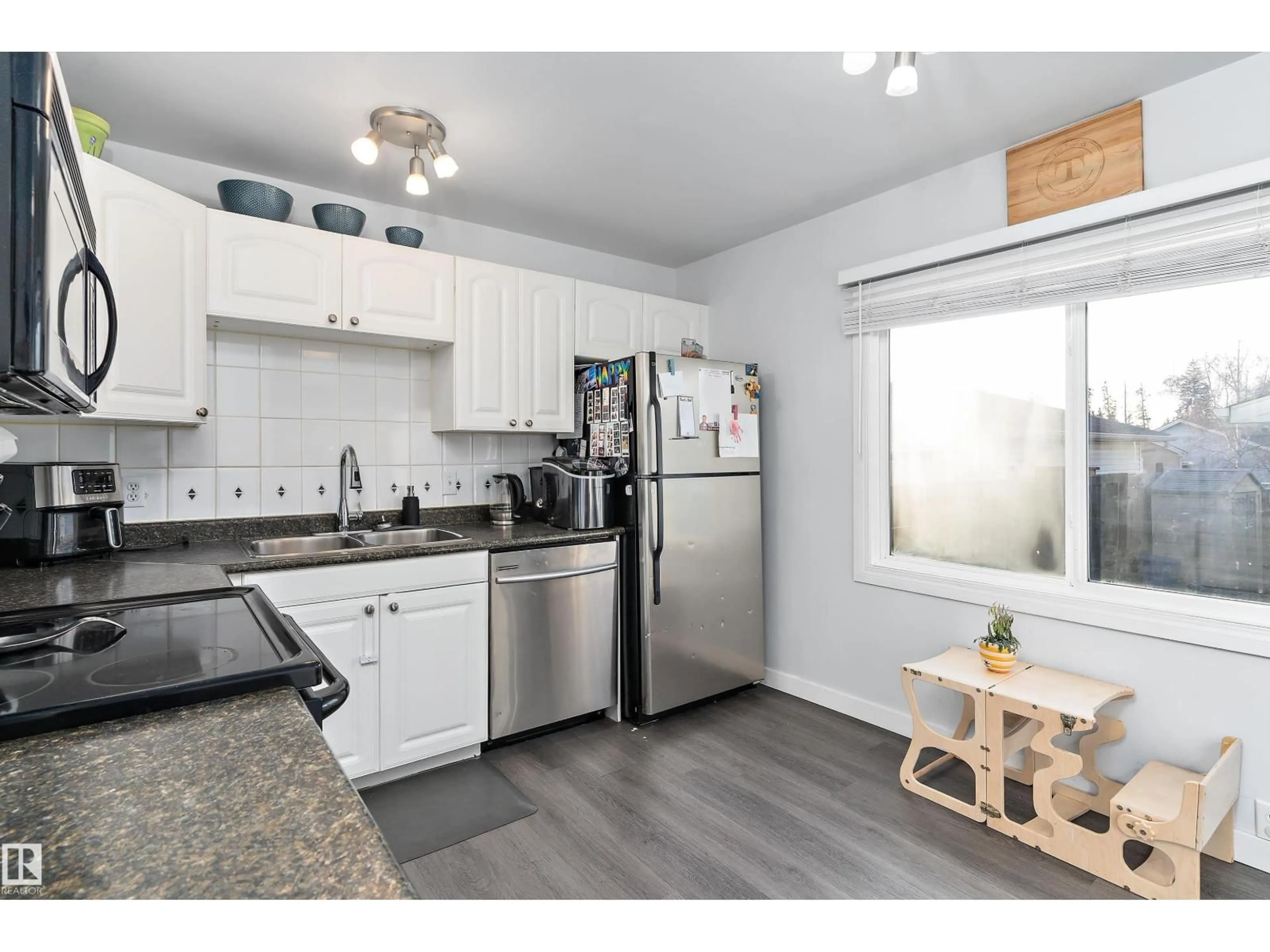 Open concept kitchen, wood/laminate floor for NW - 3320 48 ST, Edmonton Alberta T6L4J1
