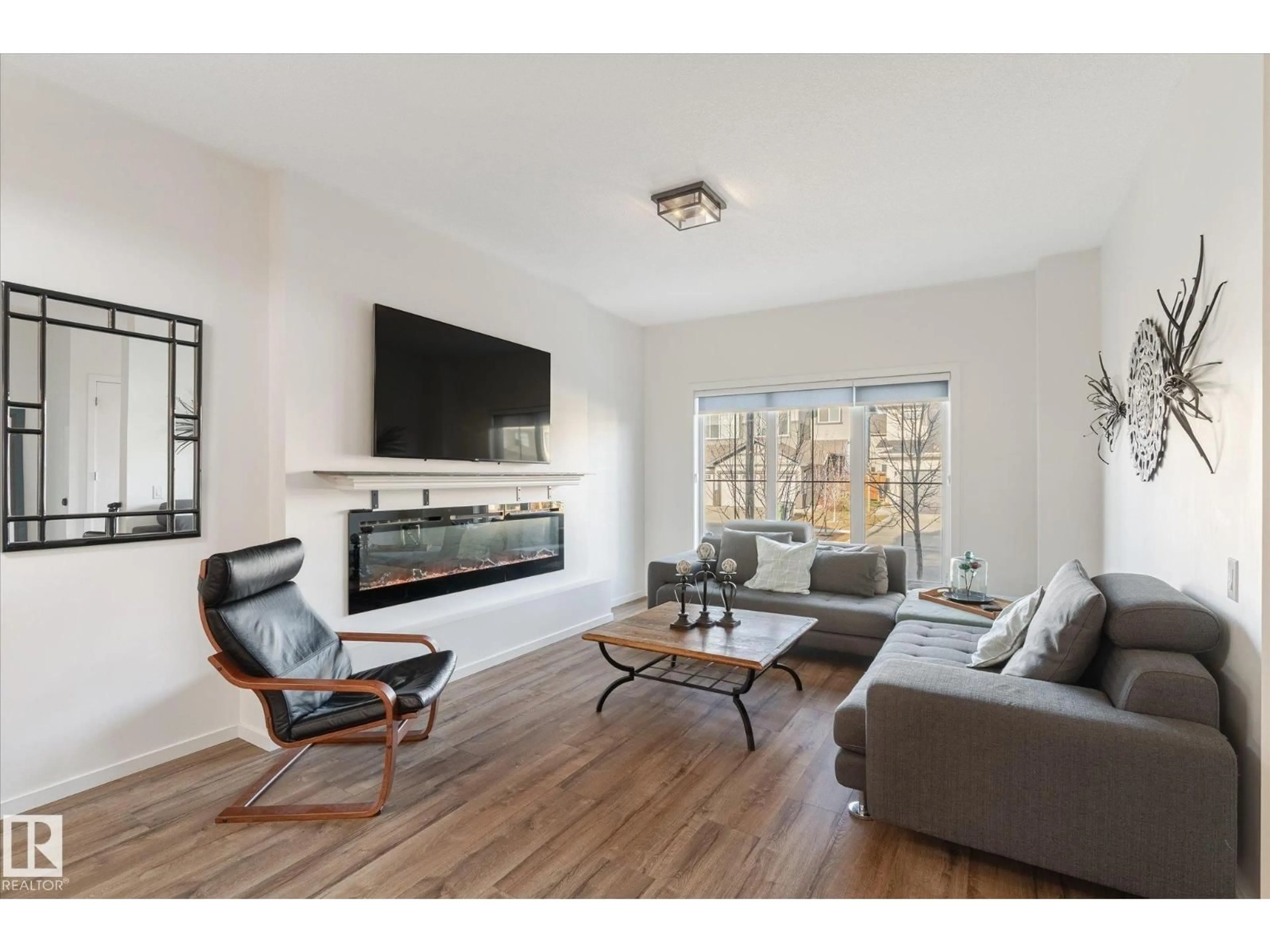 Living room with furniture, wood/laminate floor for 6613 47 AV, Beaumont Alberta T4X2X5