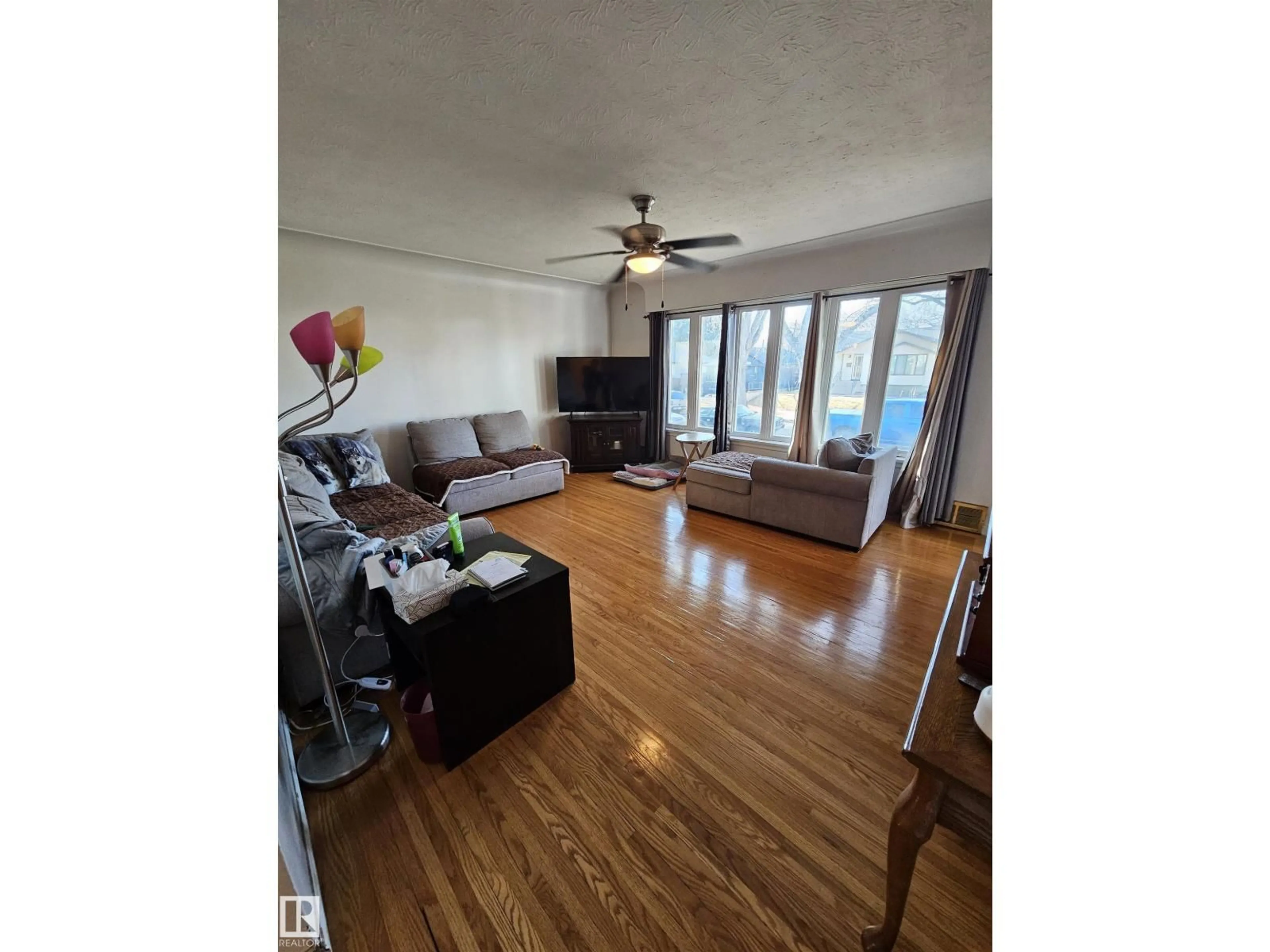Living room with furniture, wood/laminate floor for 12019 51 ST, Edmonton Alberta T5W3G6