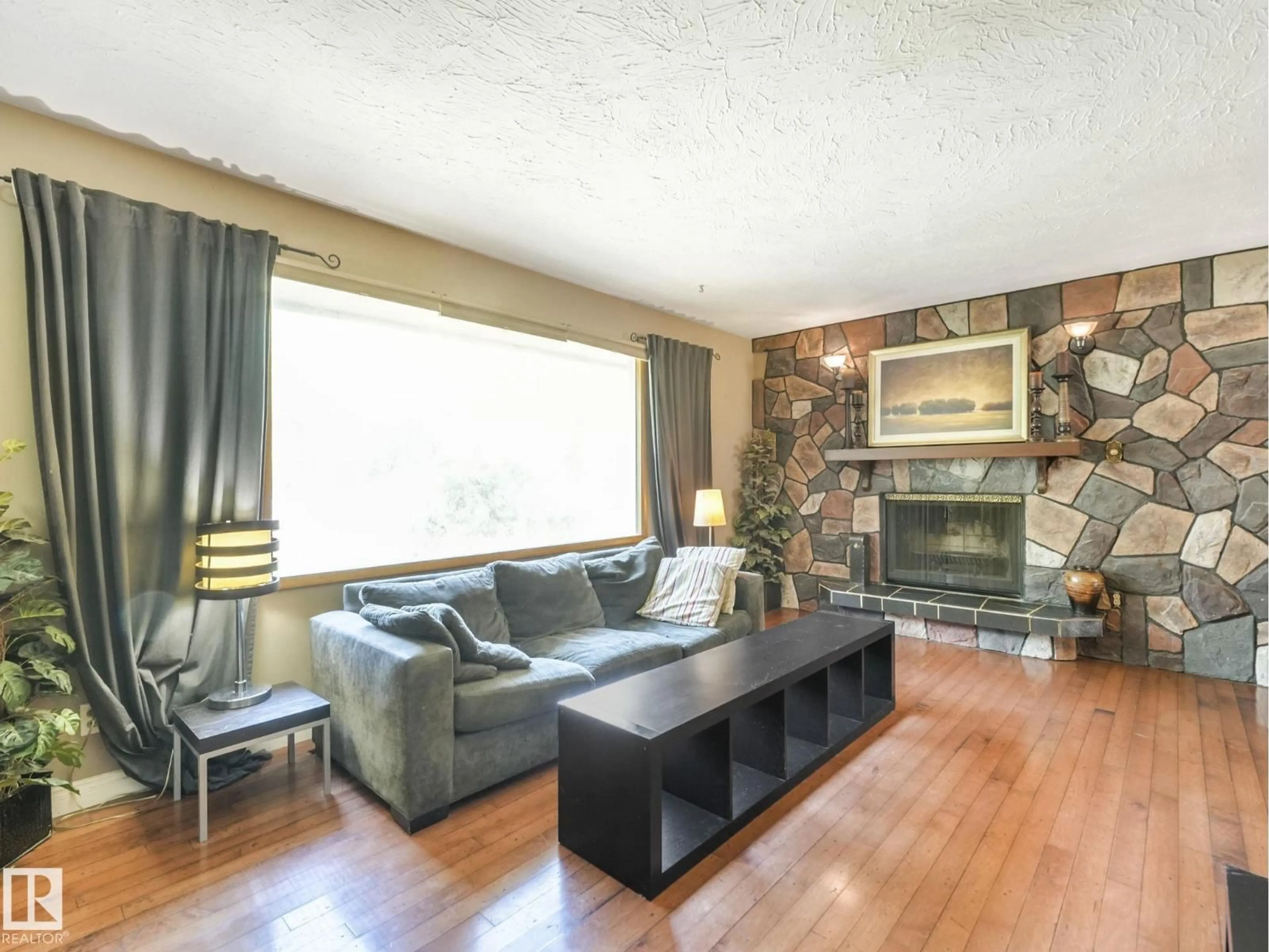 Living room with furniture, wood/laminate floor for 8905 156 ST, Edmonton Alberta T5R1Y6