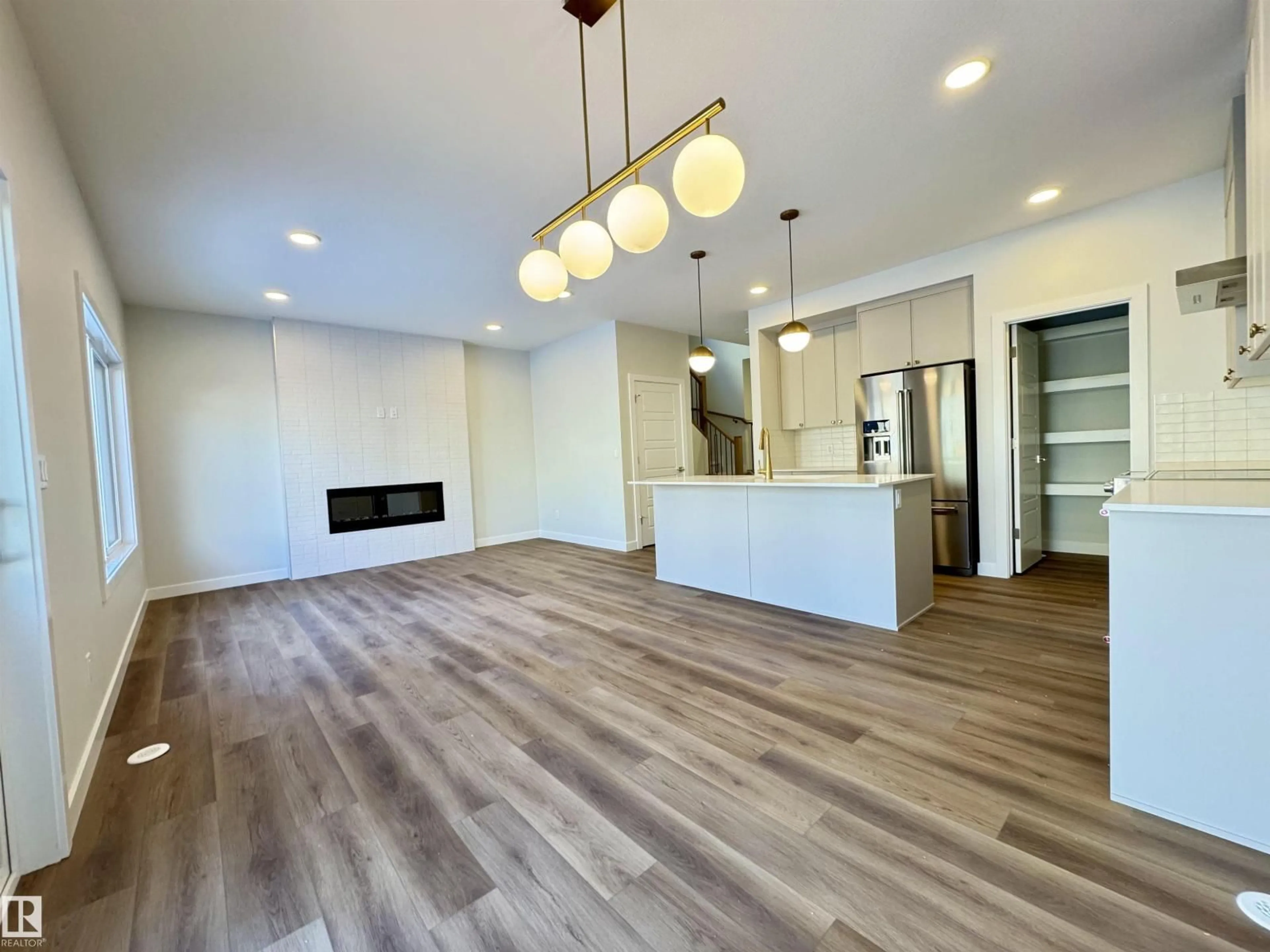 Open concept kitchen, wood/laminate floor for 3212 DIXON WY, Edmonton Alberta T6W5L3