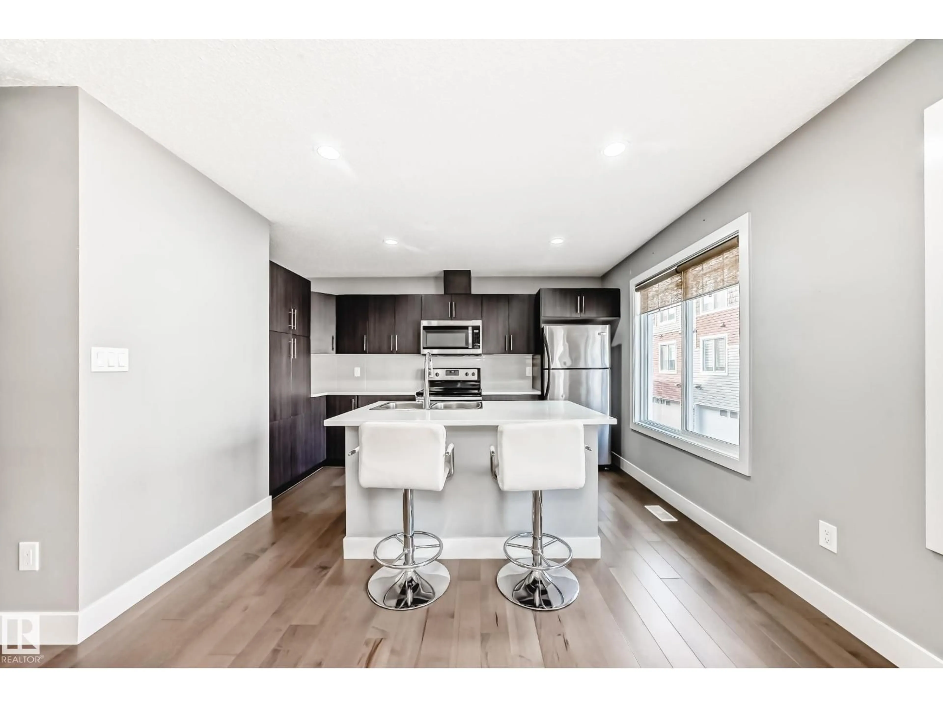 Open concept kitchen, wood/laminate floor for #23 - 2922 MAPLE WY, Edmonton Alberta T6T1A5