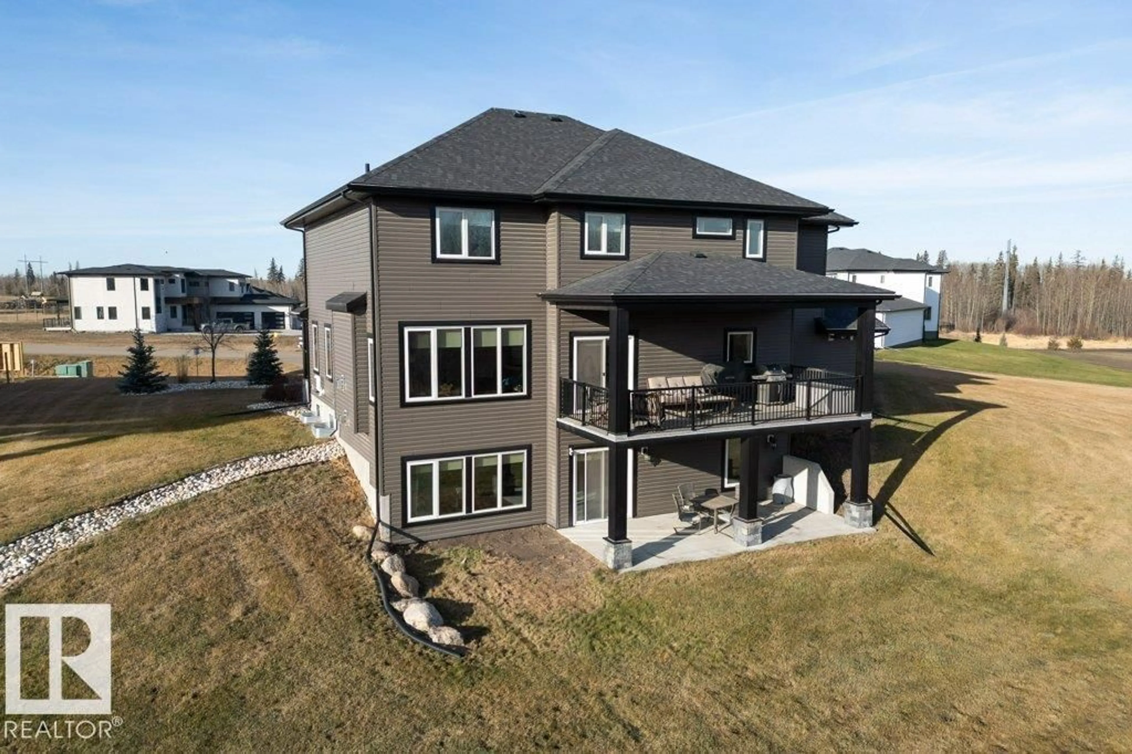 A pic from outside/outdoor area/front of a property/back of a property/a pic from drone, water/lake/river/ocean view for #7 - 26409 TWP ROAD 532 A, Rural Parkland County Alberta T7X3W6